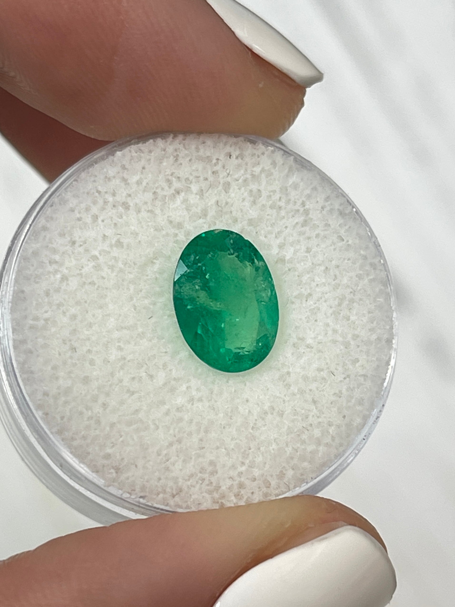 Natural 1.94 carat oval cut Colombian emerald from JR Colombian Emeralds, showcasing vibrant green color and clarity.