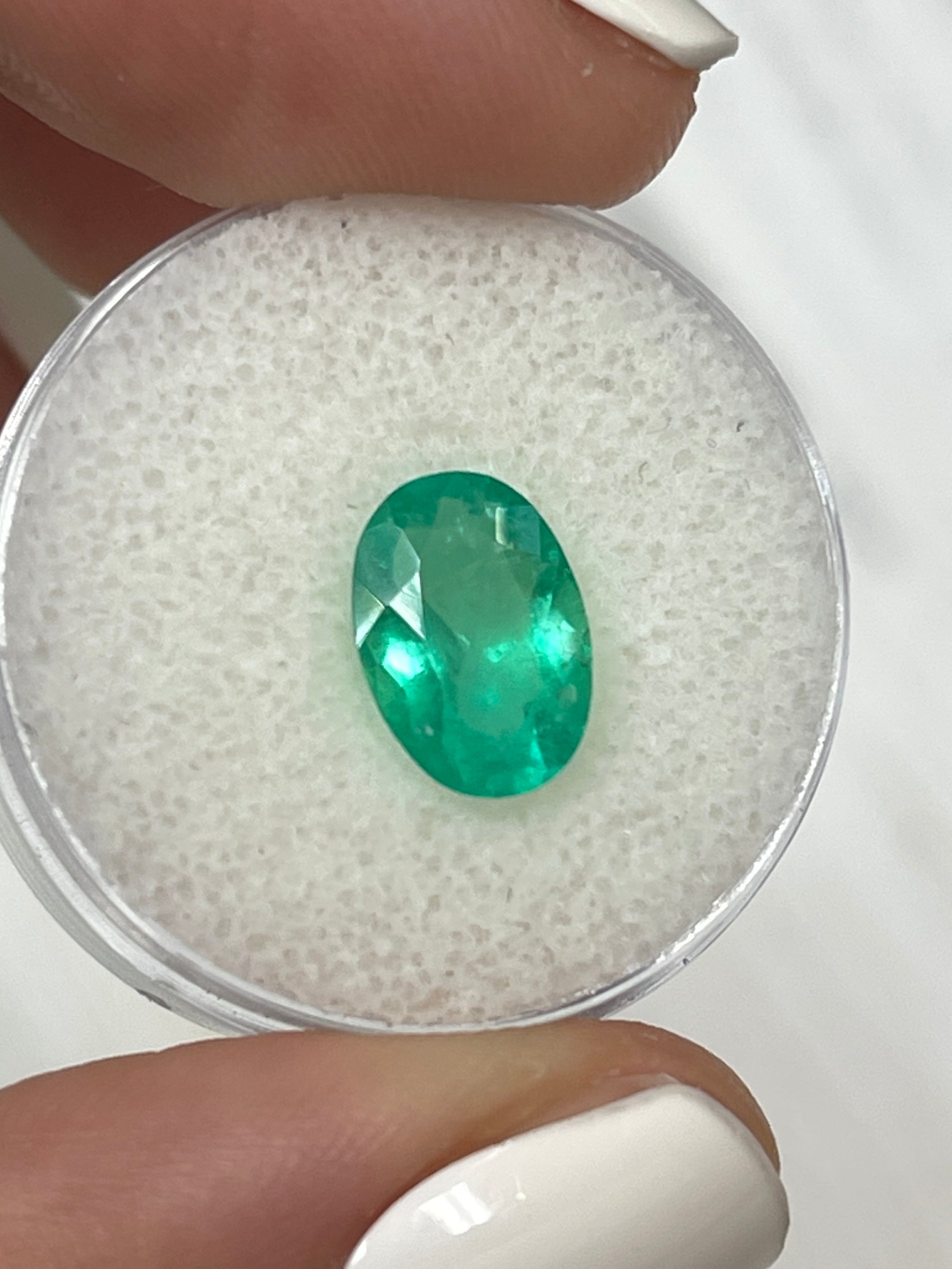 Elongated 11x8mm apple green Colombian emerald loose gemstone, 1.96 carats, oval cut by JR Colombian Emeralds.