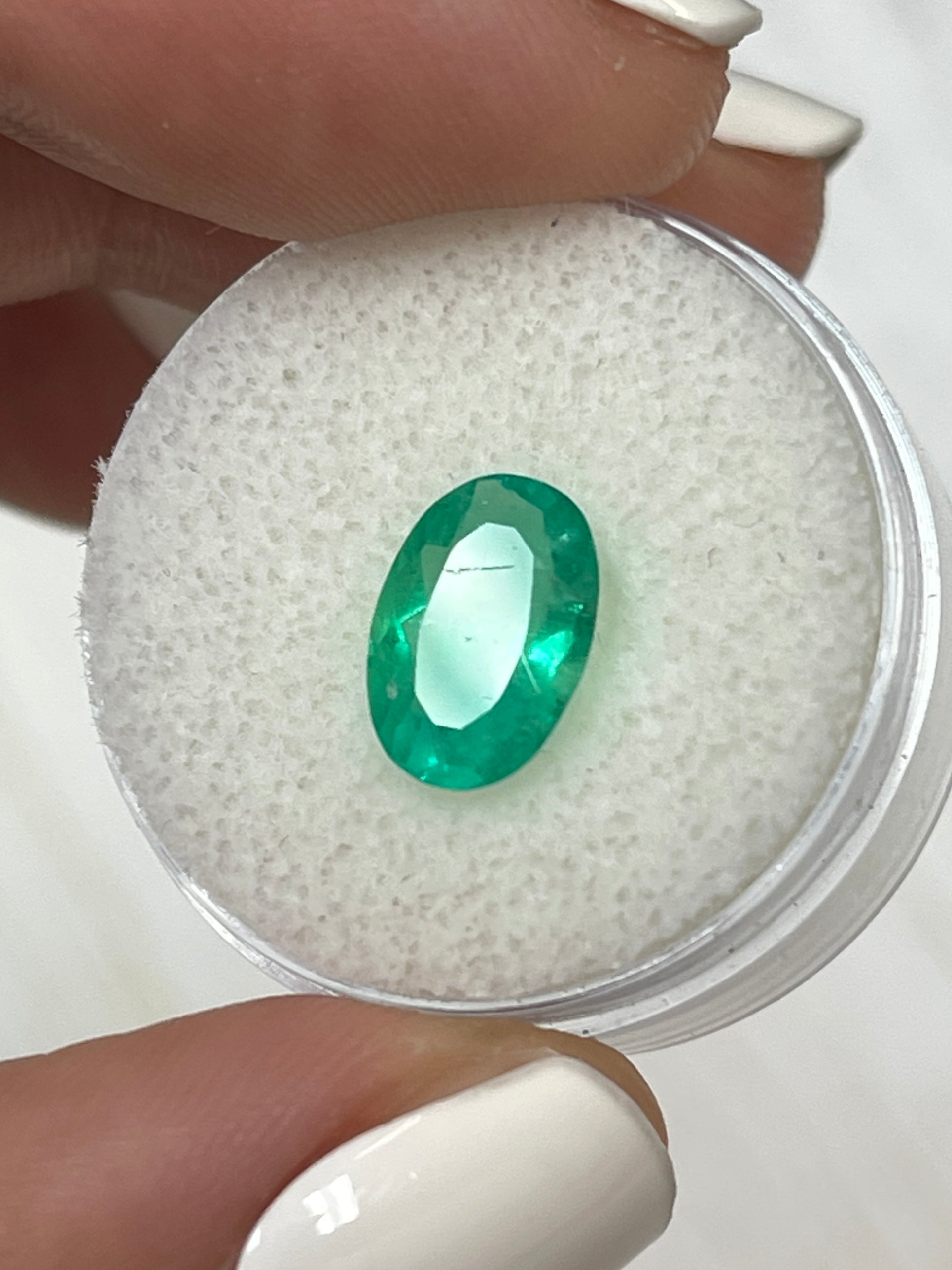 1.96 carat elongated oval Colombian emerald from JR Colombian Emeralds, vibrant apple green, loose gemstone with oval cut.