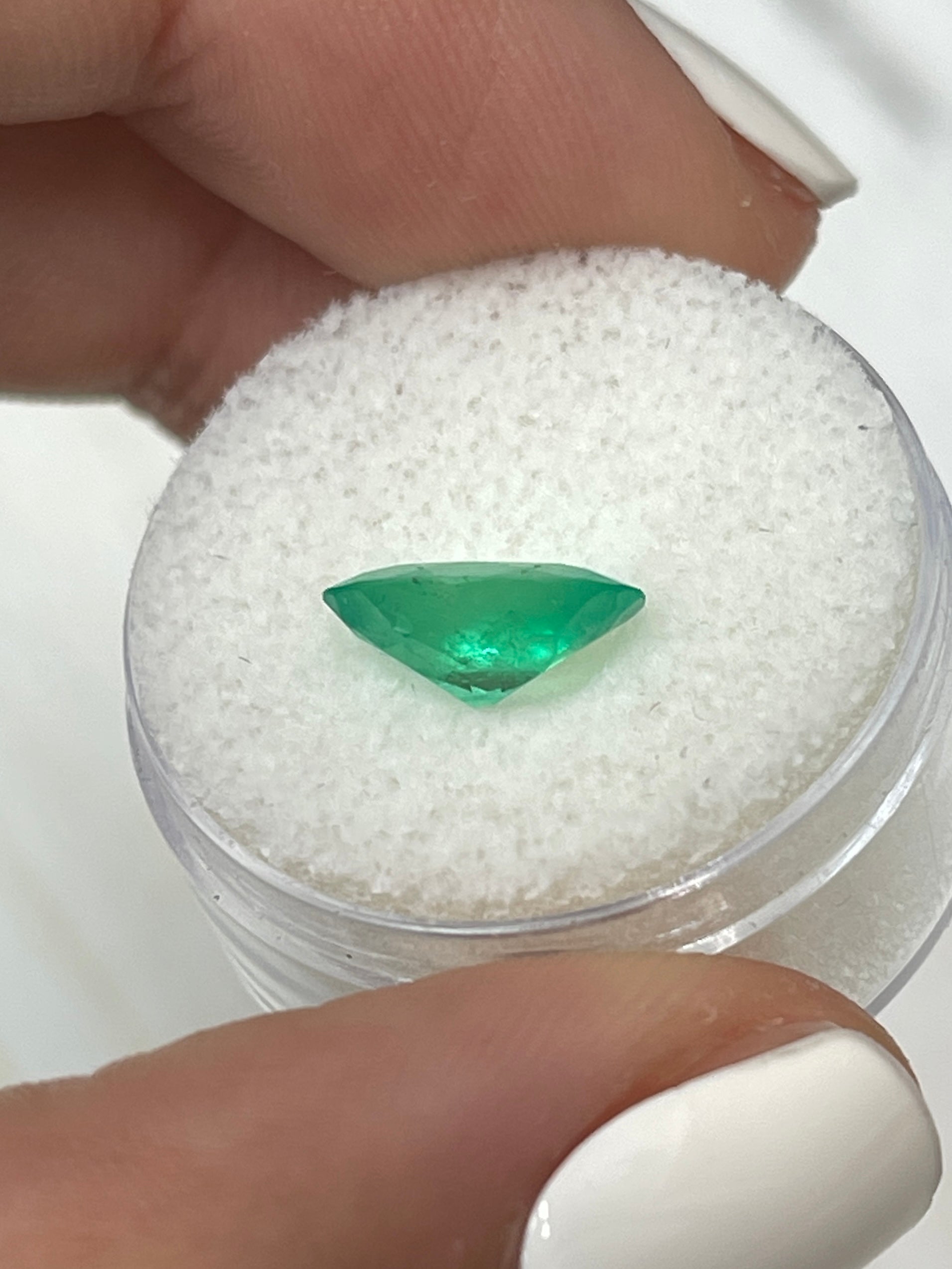 Elongated 11x8 mm apple green Colombian emerald loose gemstone with oval cut, 1.96 carats from JR Colombian Emeralds.