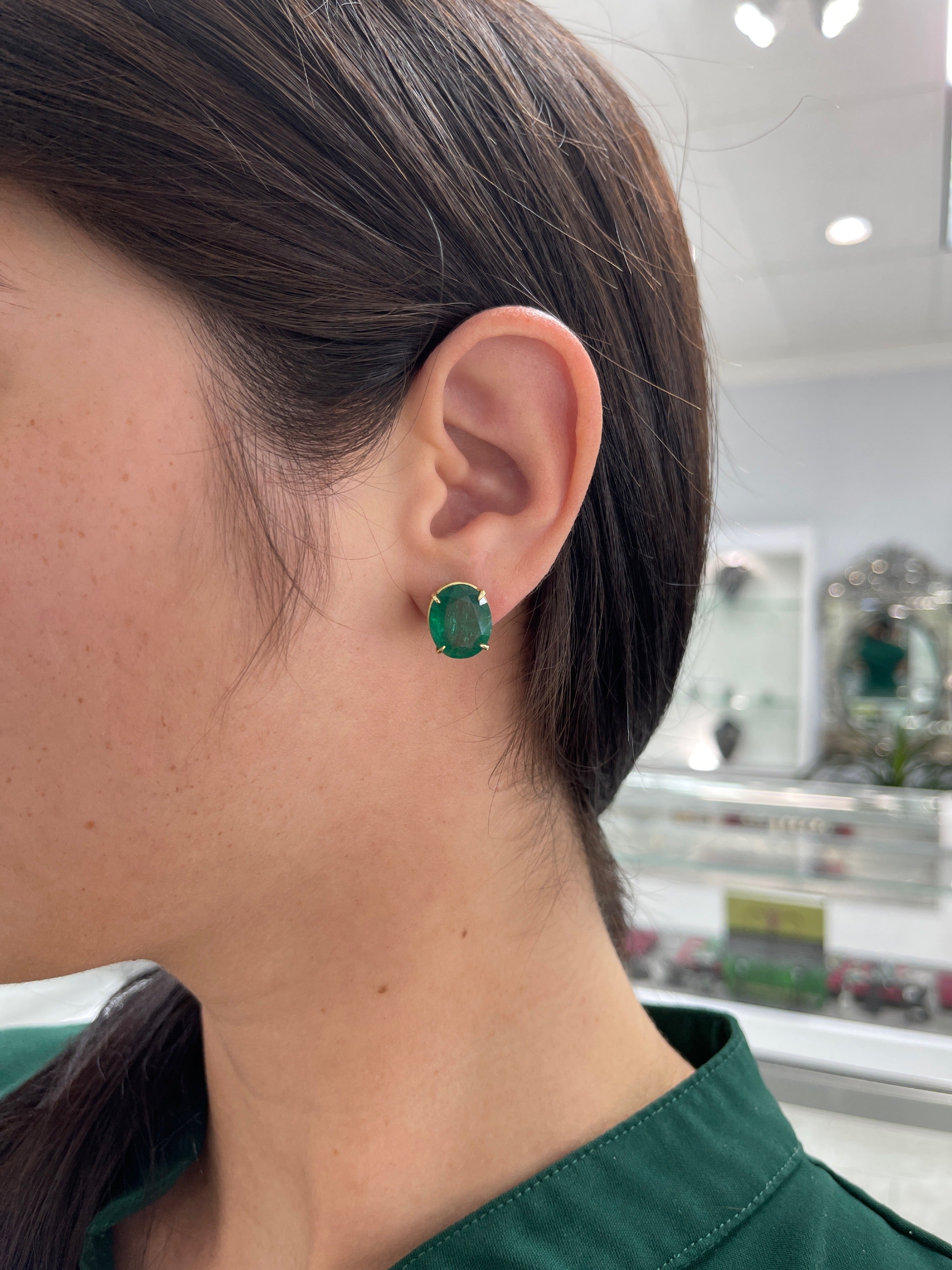 Large dark green Zambian oval stud earrings featuring 13.61 tcw AAA fine quality emeralds set in 18K gold by JR Colombian Emeralds.