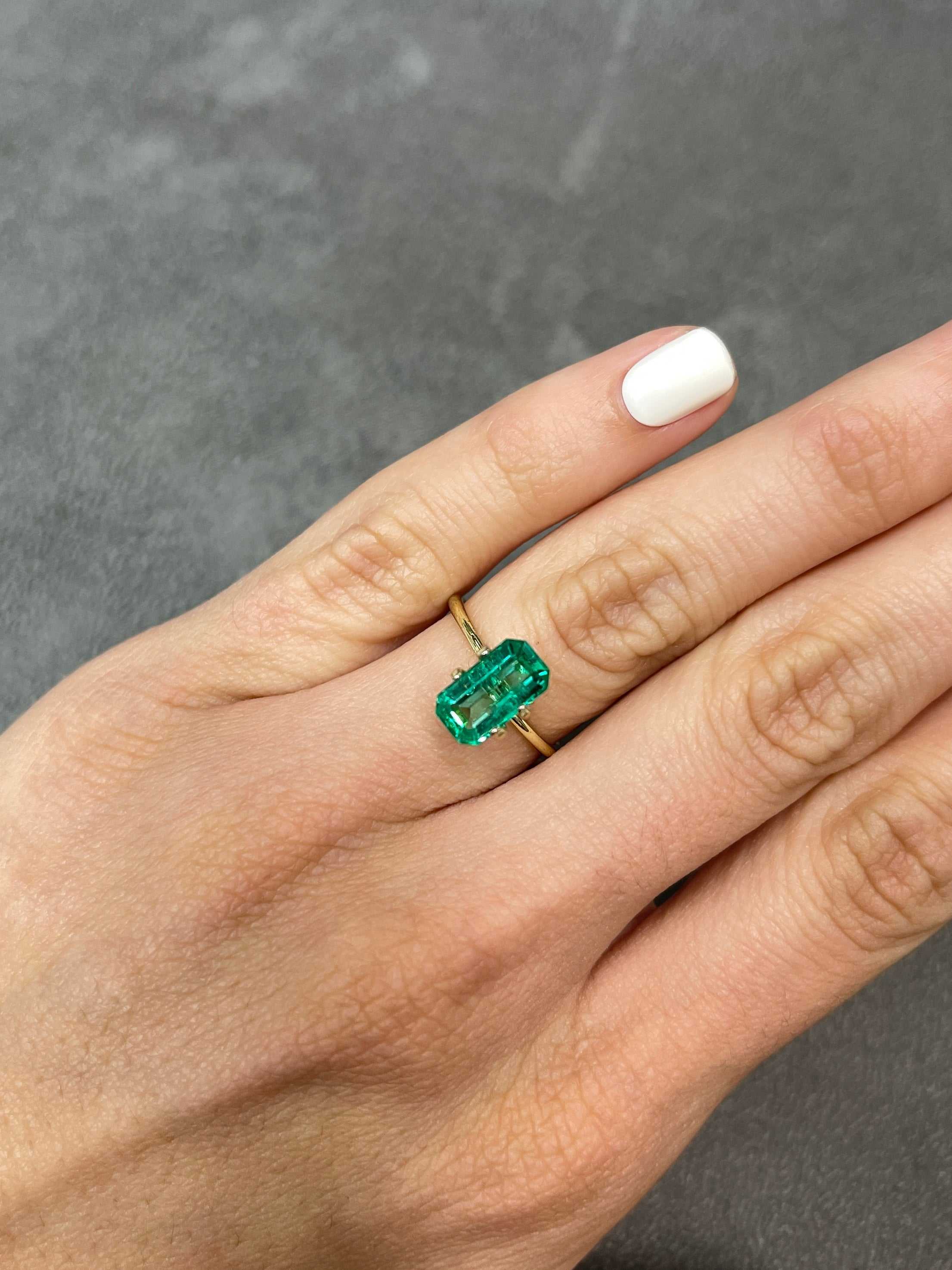 JR Colombian Emeralds 2.15-carat elongated emerald cut engagement ring with clipped corners and luminous 11x6 gemstone.