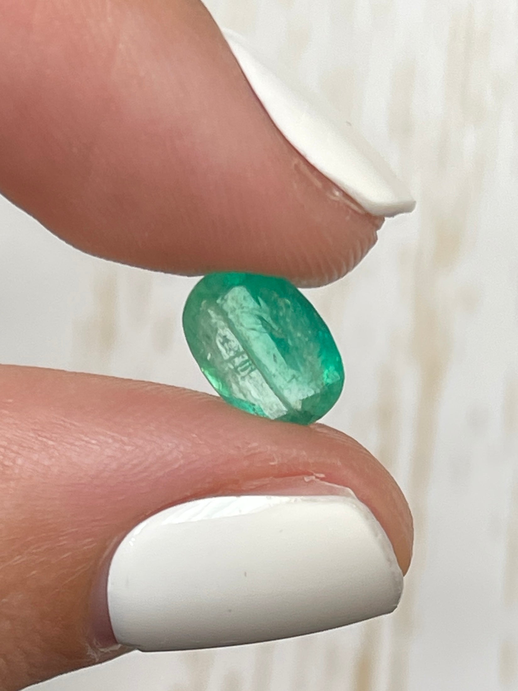Natural 2.19 carat oval cut Colombian emerald from JR Colombian Emeralds, showcasing vibrant green color and clarity.