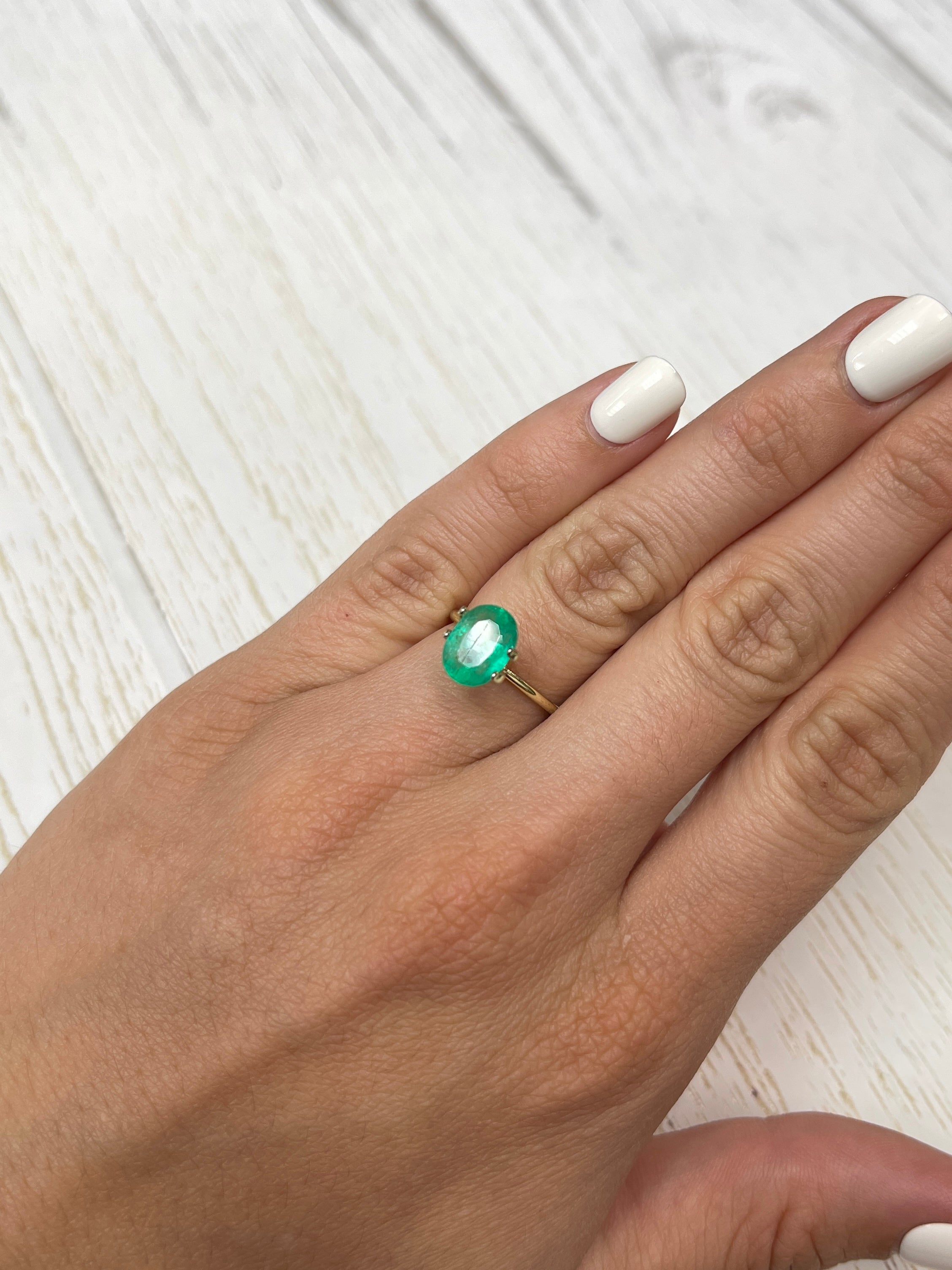 Natural 2.19 carat green Colombian emerald loose oval cut gemstone, showcasing vibrant color and clarity.