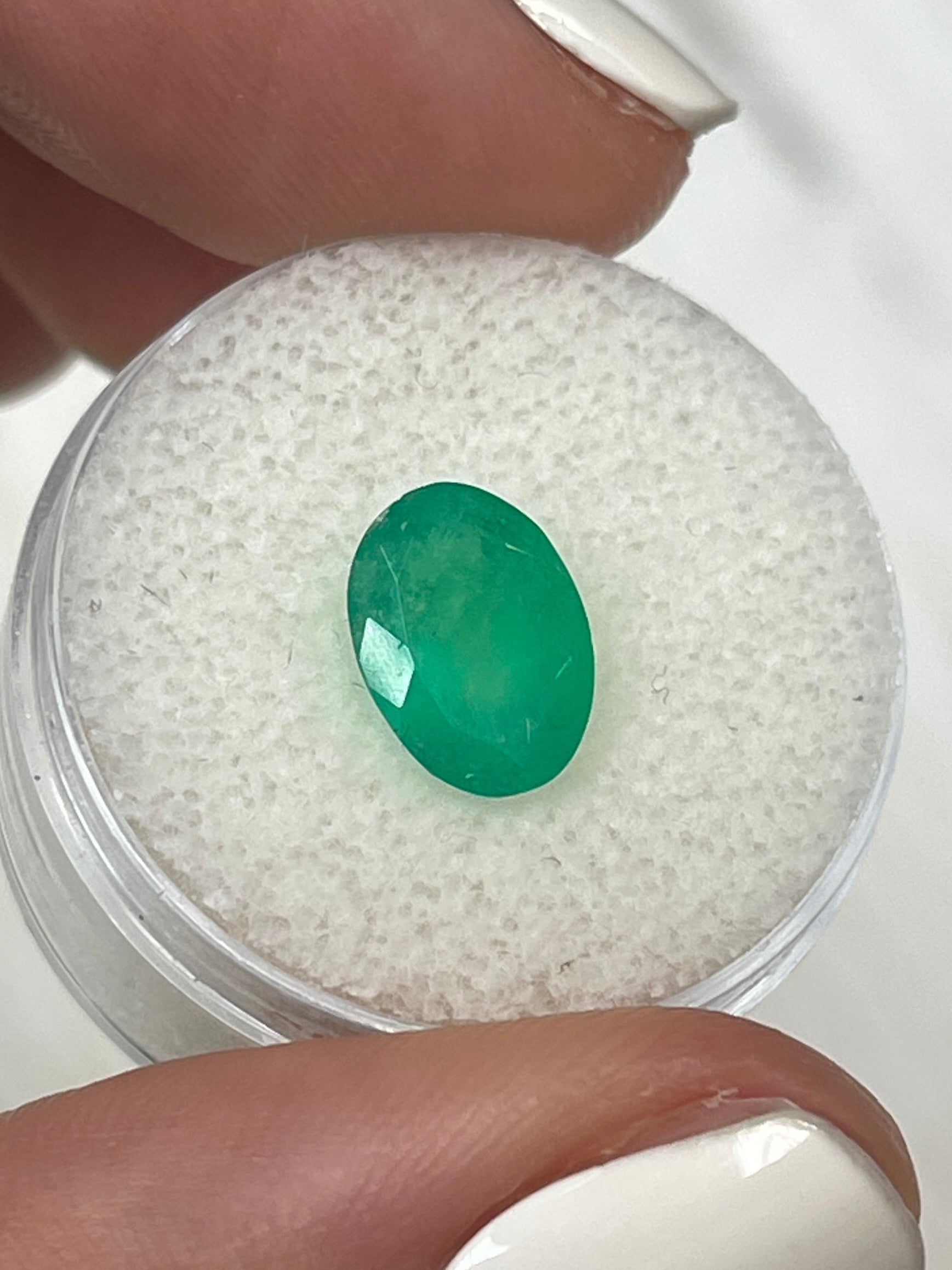 Medium forest green 2.33 carat natural Colombian emerald in oval cut, showcasing vibrant color and clarity, by JR Colombian Emeralds.