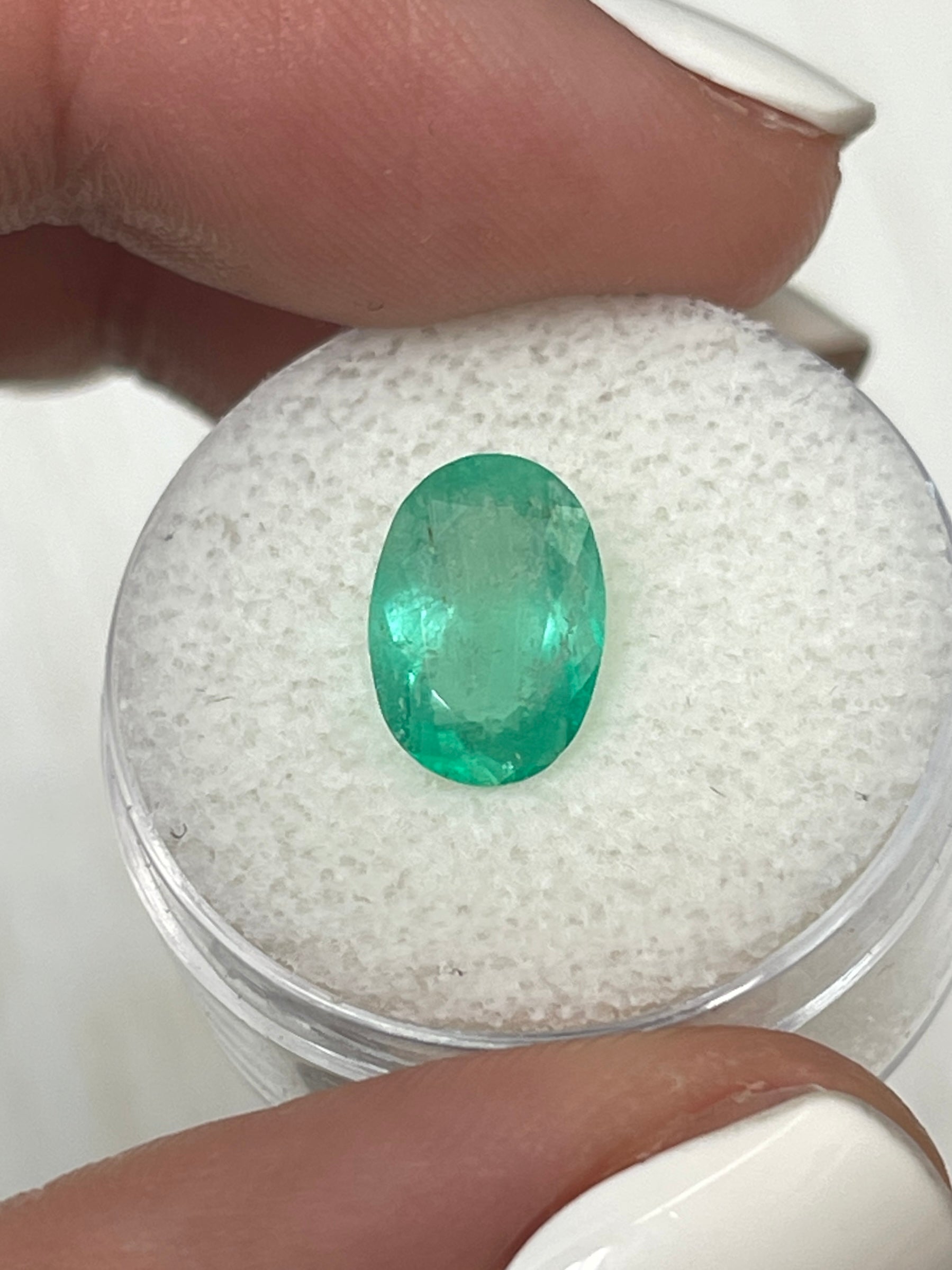 Medium light green Colombian emerald loose oval cut, 2.40 carats, from JR Colombian Emeralds, showcasing its slender shape and vibrant color.