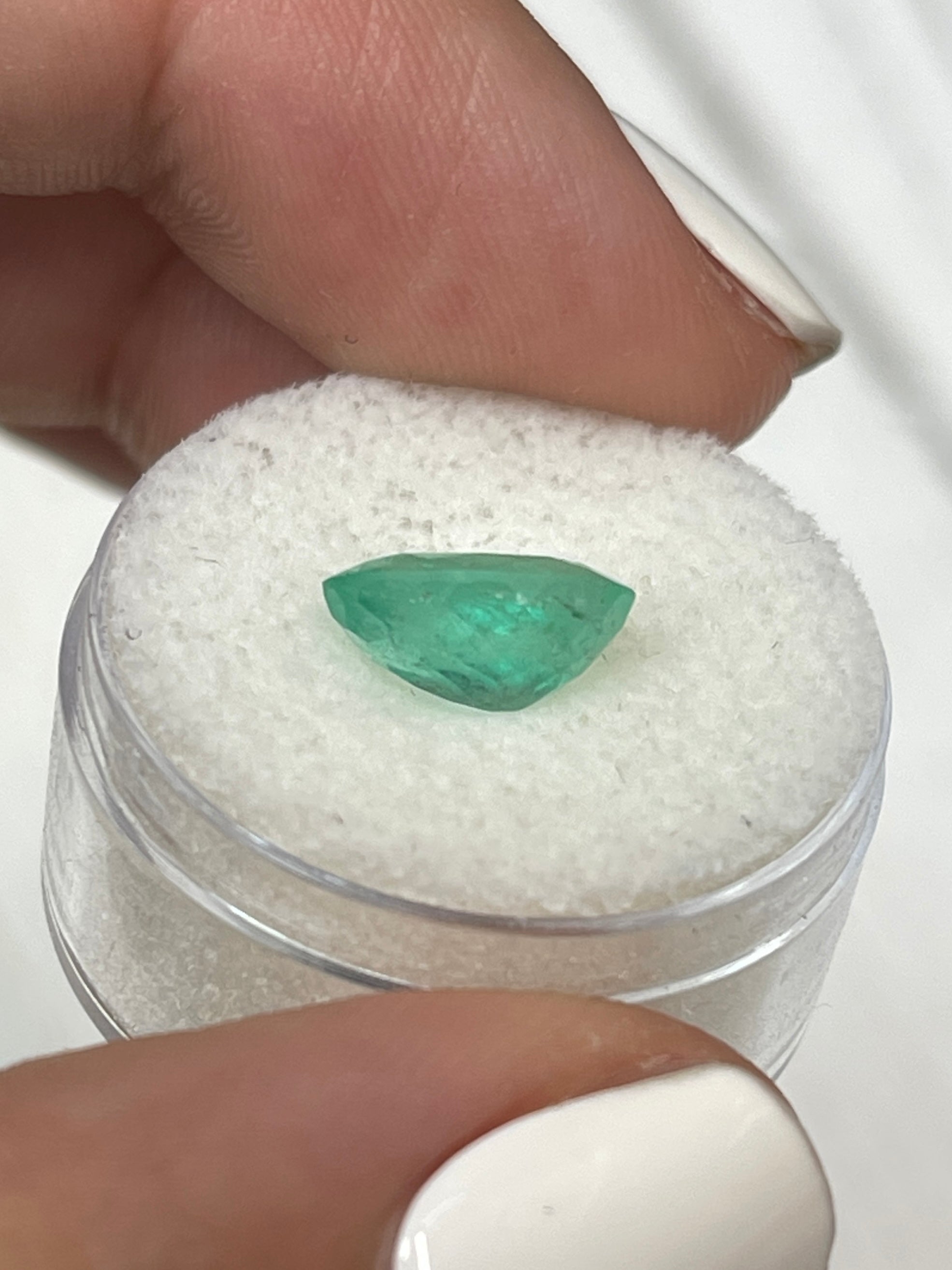 2.40 carat medium light green oval Colombian emerald loose gemstone from JR Colombian Emeralds, showcasing its vibrant color and clarity.