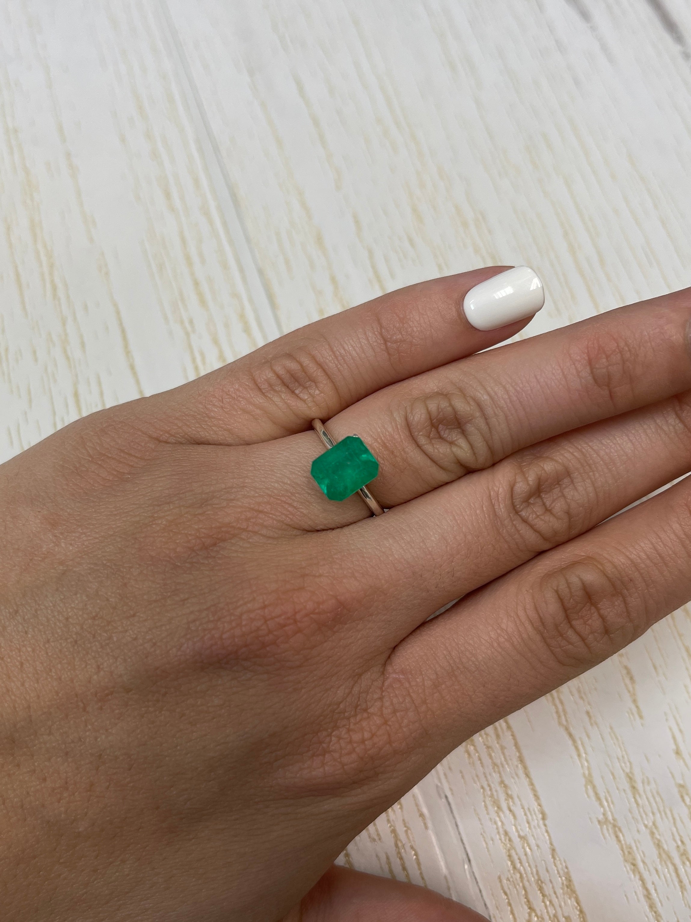 2.52 Carat intense green natural Colombian emerald loose gemstone in emerald cut, showcasing vibrant color and clarity.