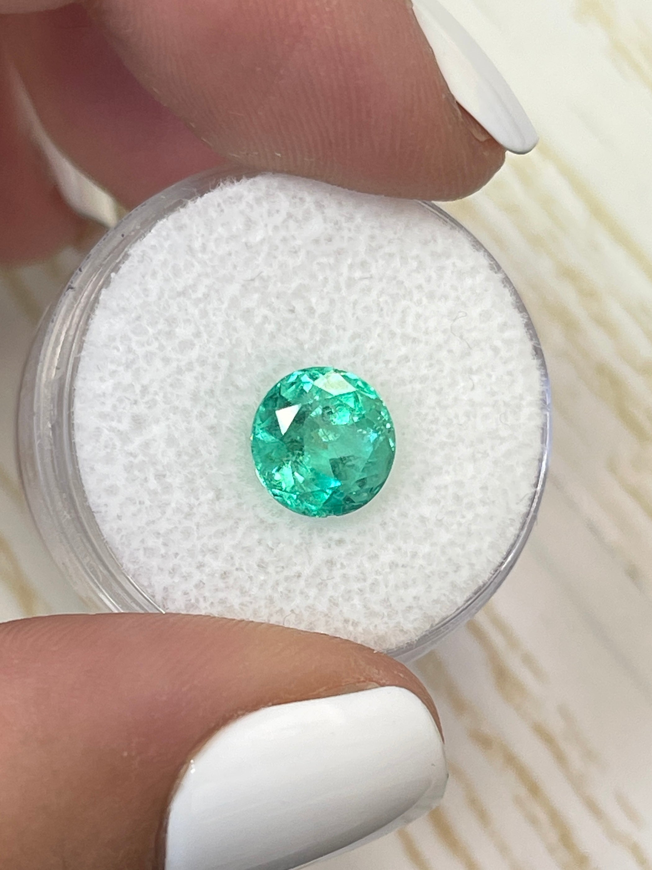 2.56 carat medium green natural round Colombian emerald loose gemstone with vibrant color and clarity.