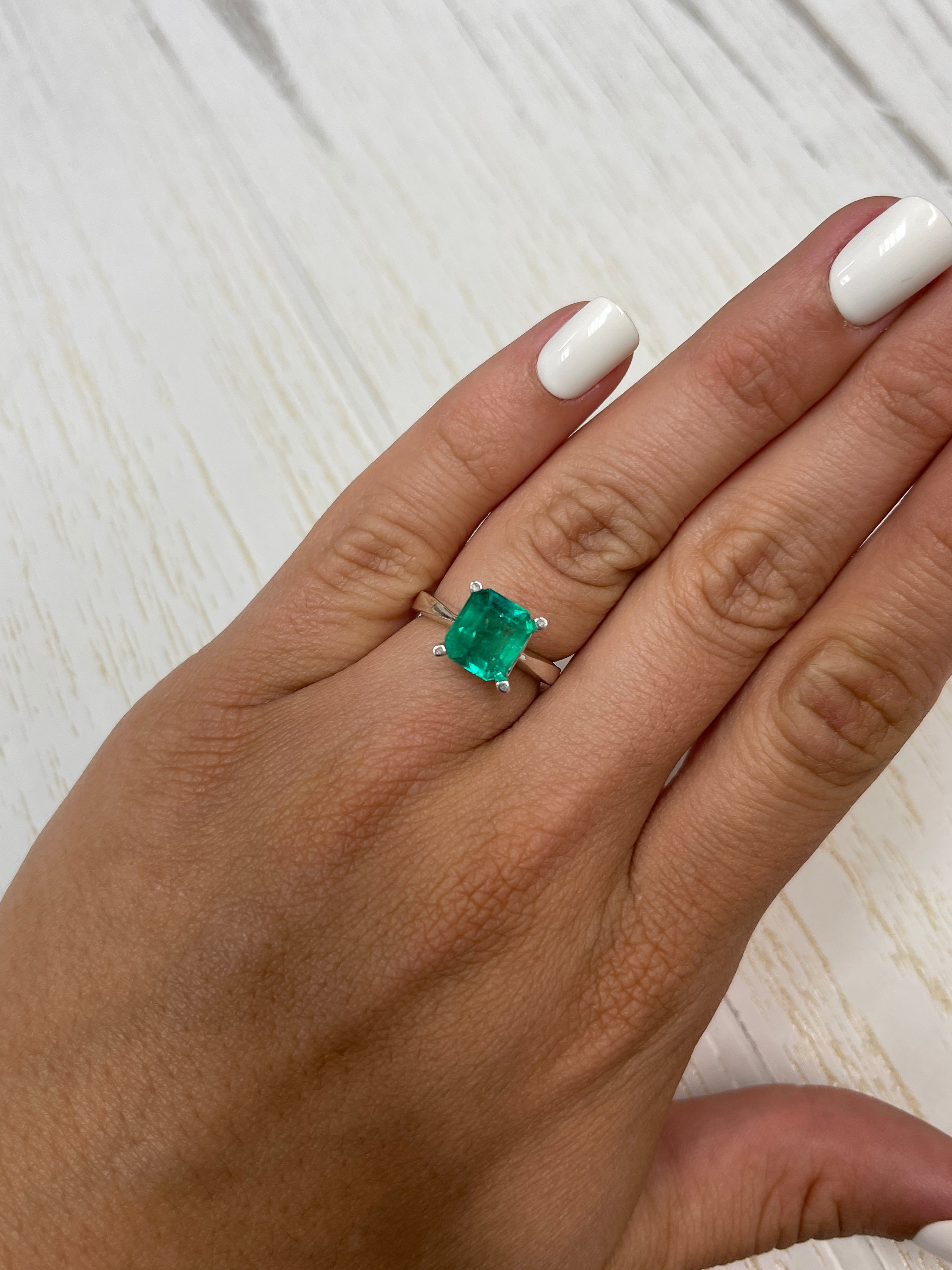 2.63 carat deep bluish natural Colombian emerald loose gemstone in an emerald cut, showcasing rich color and clarity.