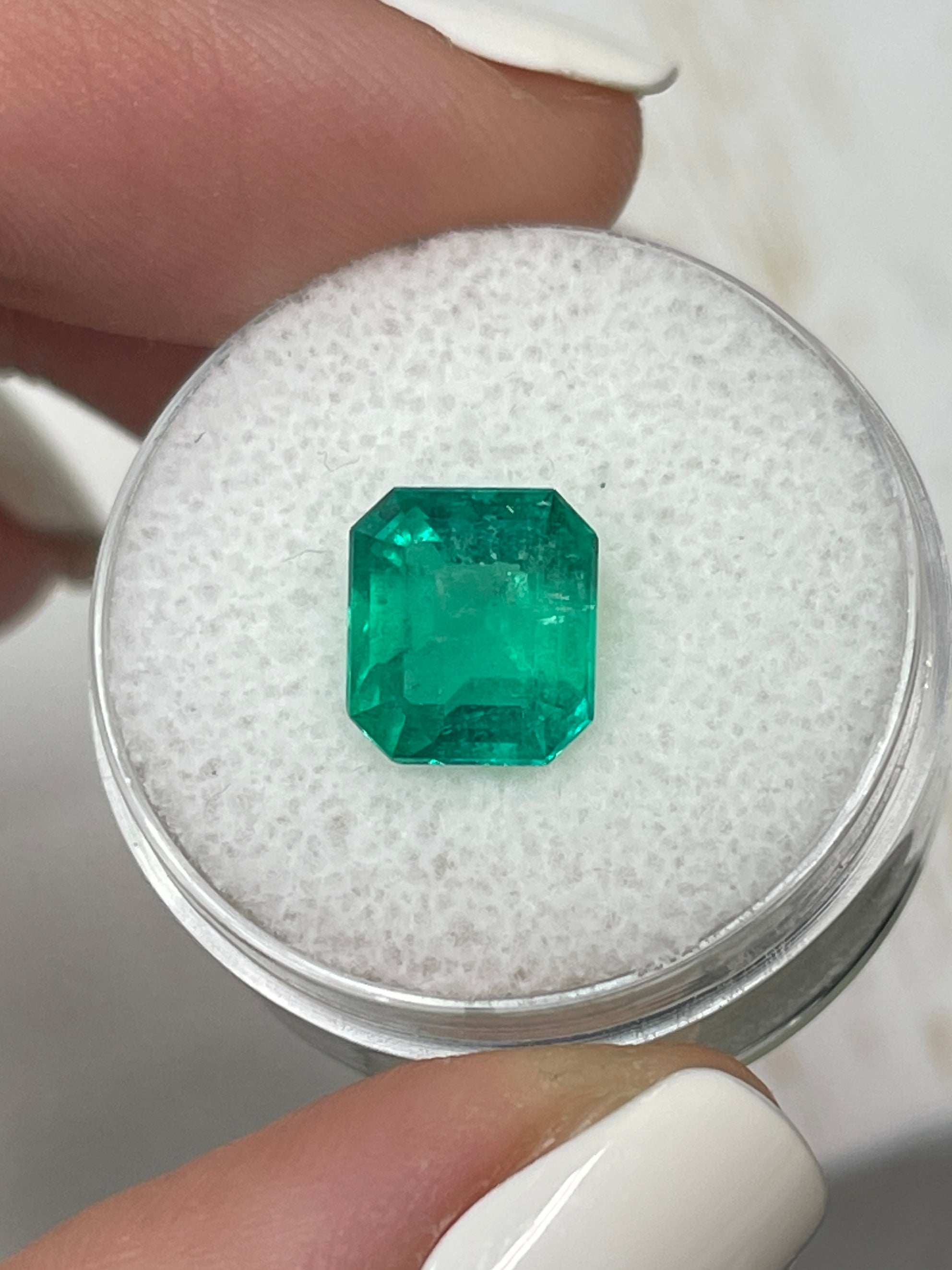 Deep bluish 2.63 carat natural Colombian emerald in emerald cut, showcasing rich color and clarity, from JR Colombian Emeralds.