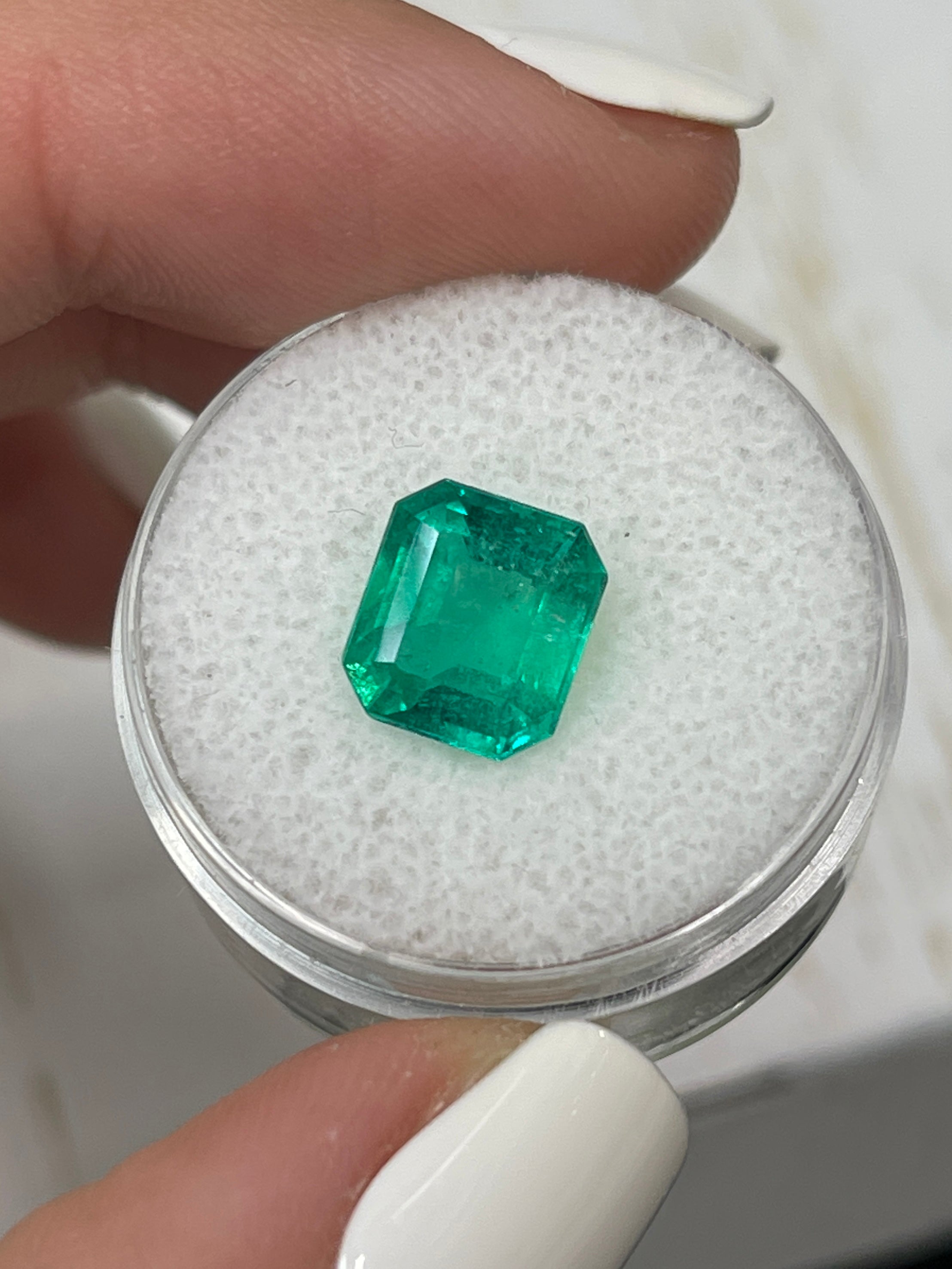 Deep bluish 2.63 carat natural Colombian emerald in an emerald cut, showcasing vibrant color and clarity from JR Colombian Emeralds.