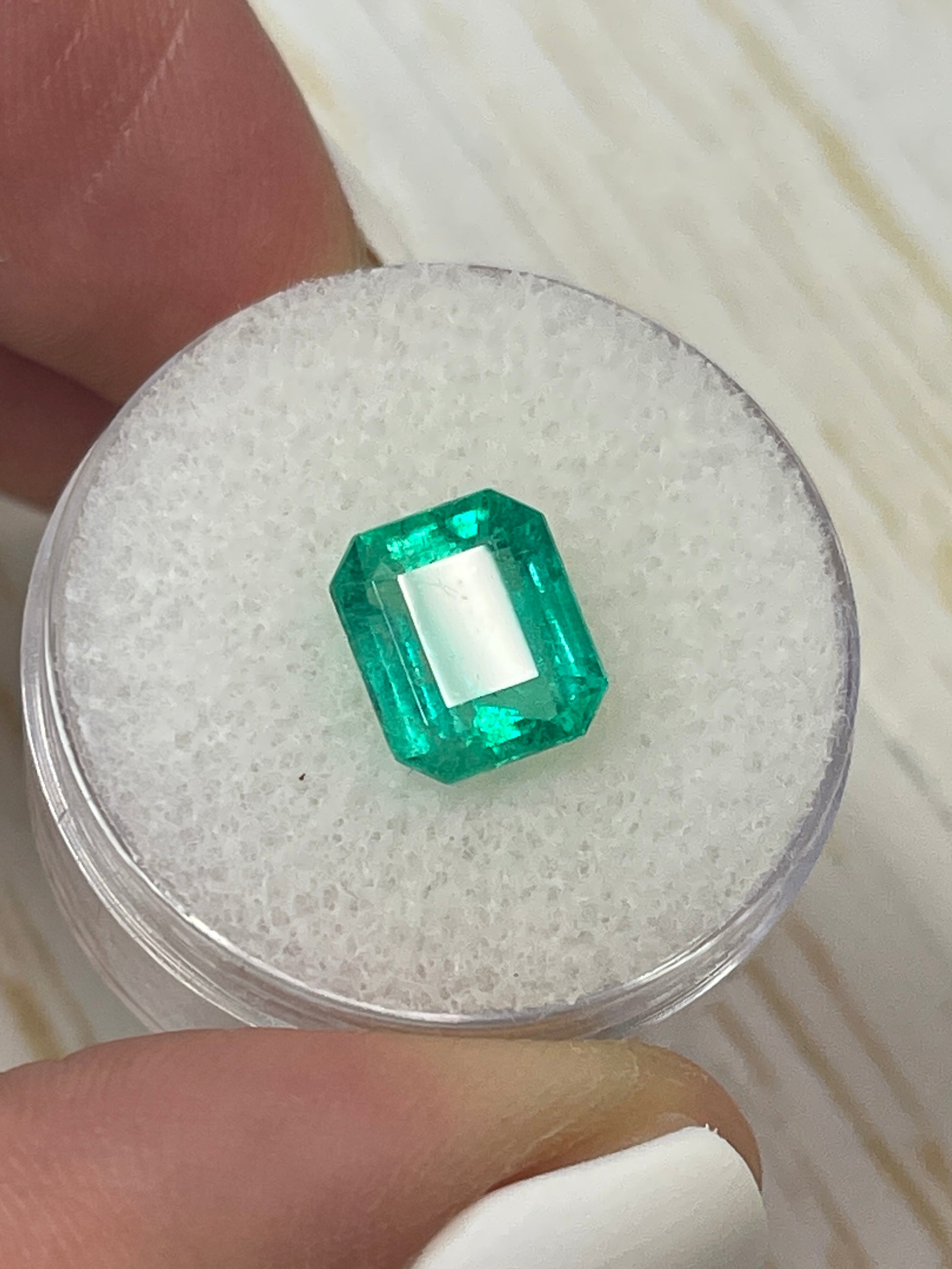 2.68 carat natural Colombian emerald loose stone with emerald cut, showcasing vibrant green color and chunky shape.