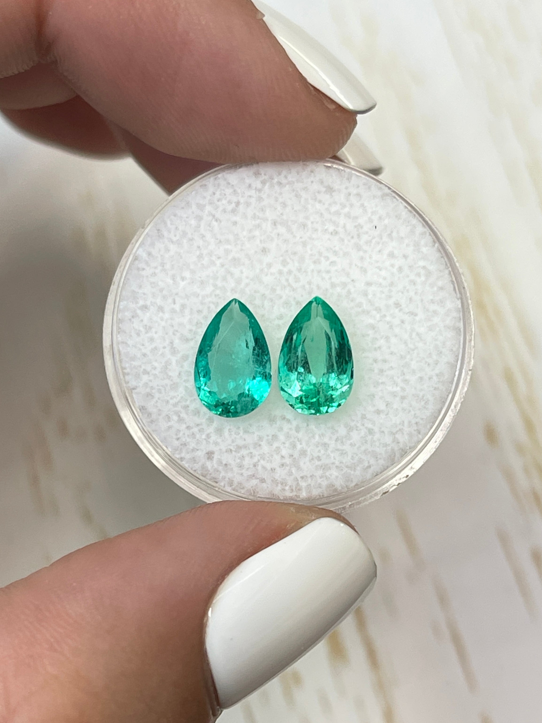 Luke custom emerald and diamond earrings in 14k yellow gold with Colombian pear-cut emeralds and 2.71 tcw, matching loose stones.