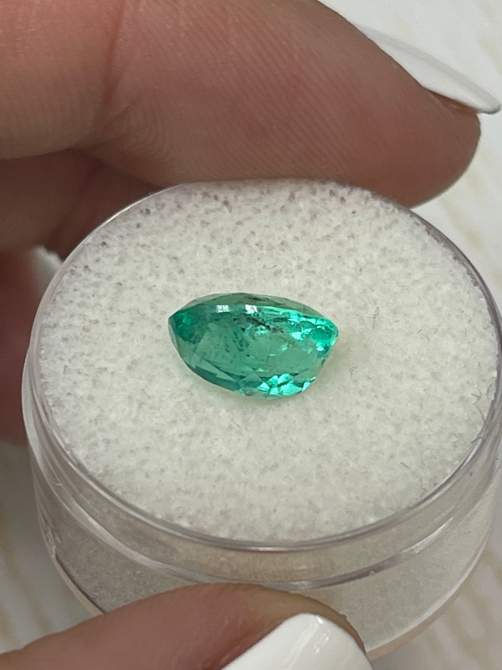 Vibrant 2.83 carat oval cut Colombian emerald with natural freckles, loose gemstone from JR Colombian Emeralds.