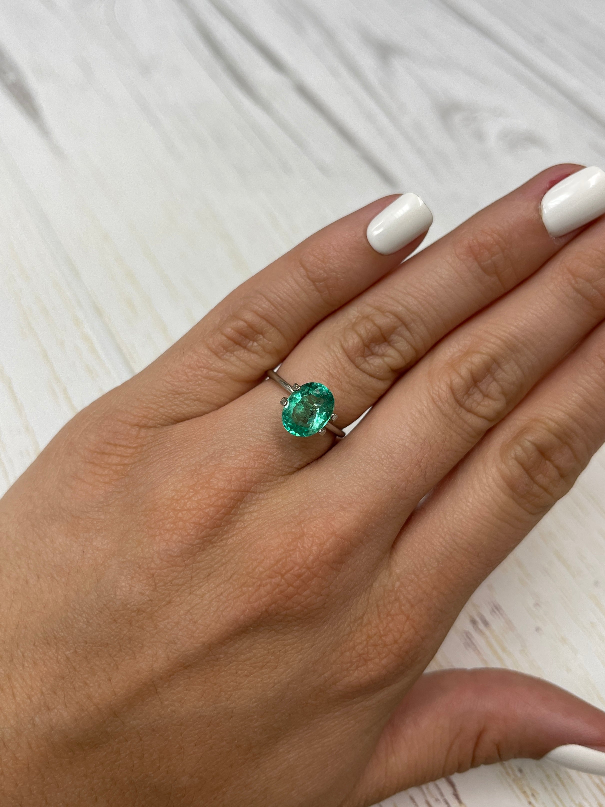 Vibrant 2.83 carat green Colombian emerald in oval cut with natural freckling, loose gemstone from JR Colombian Emeralds.