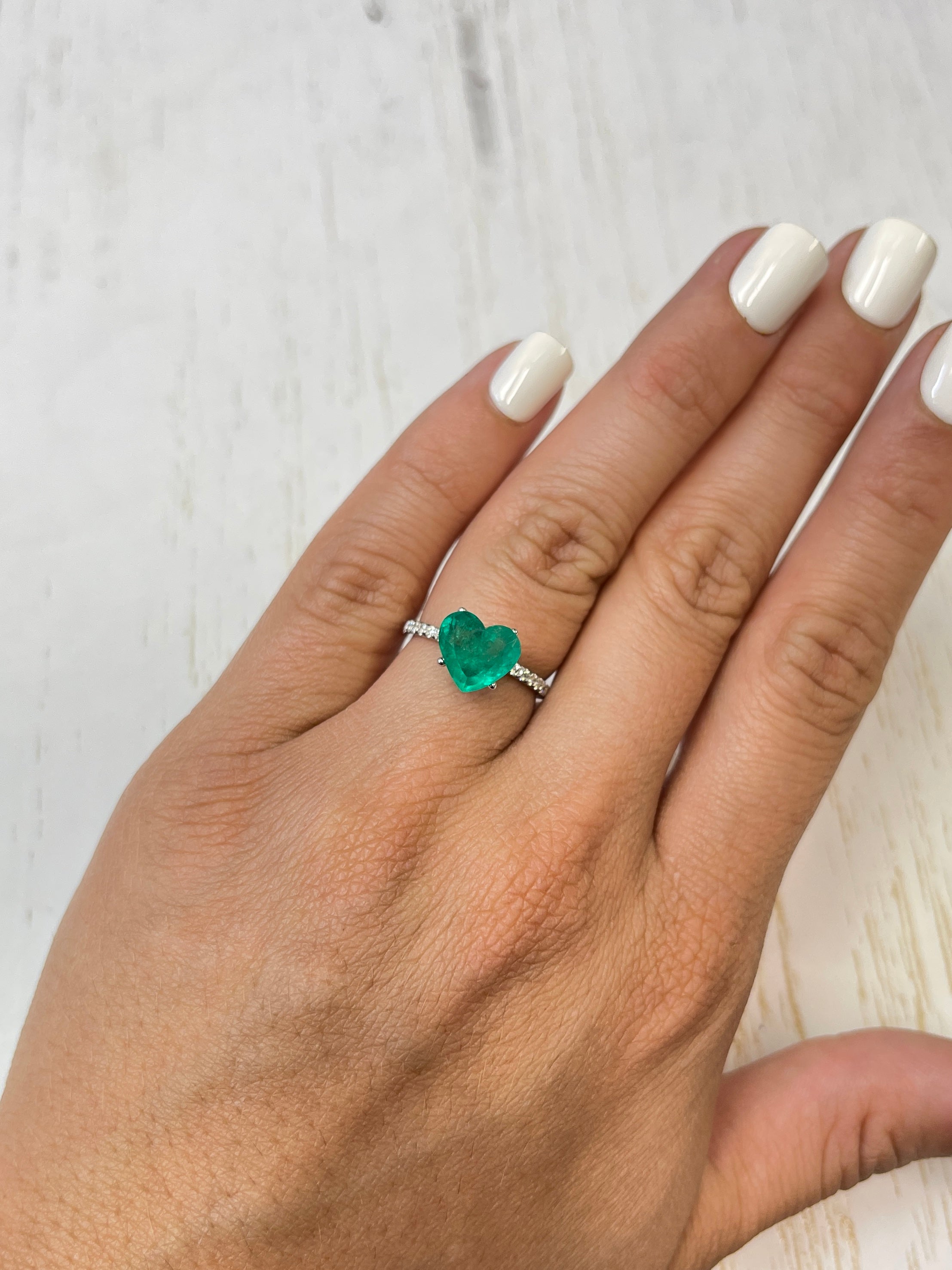 Bright green 2.87 carat natural Colombian emerald in heart cut, loose gemstone, showcasing vibrant color and clarity.