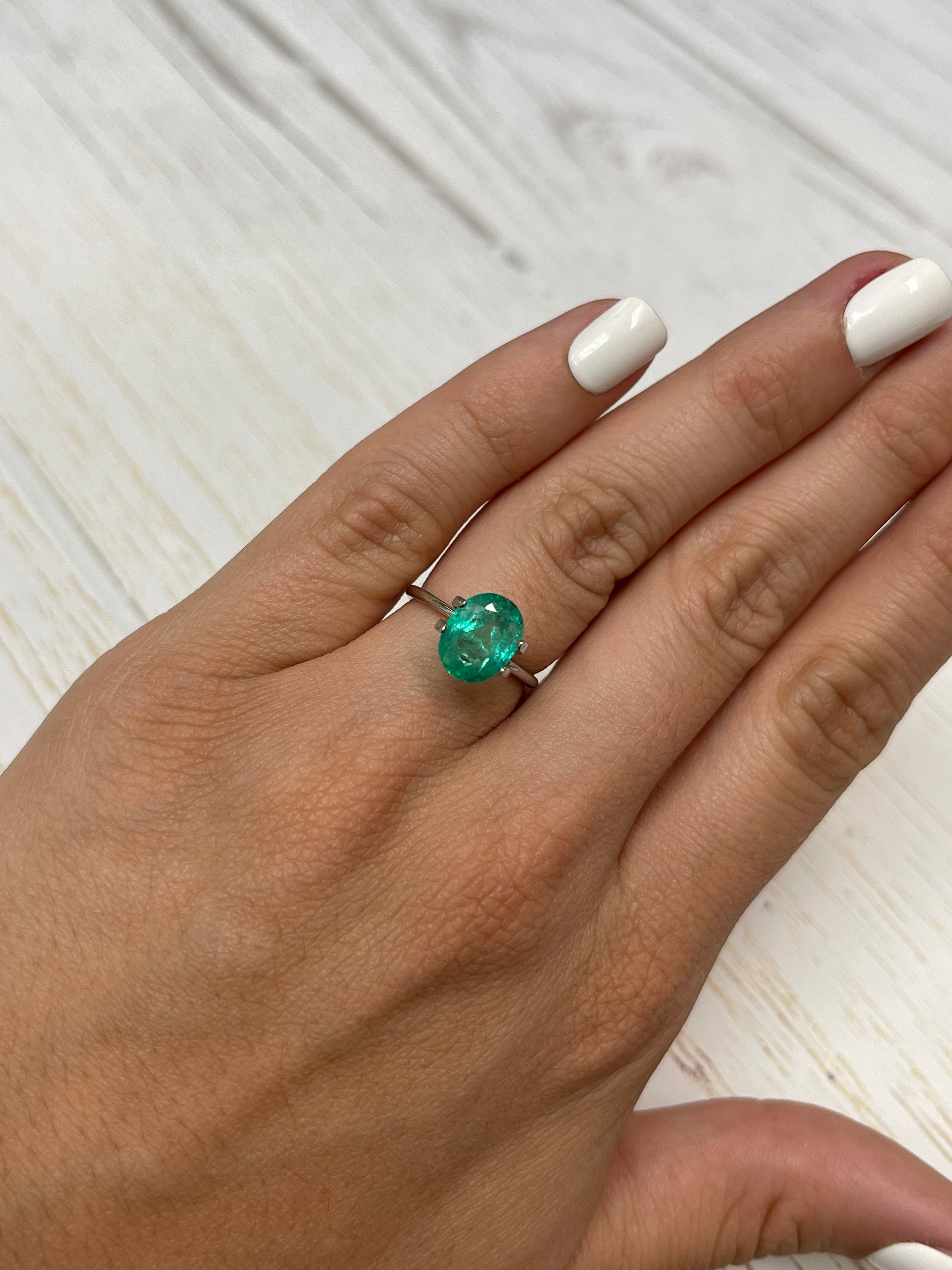2.88 carat light bluish-green natural Colombian emerald loose oval cut gemstone with vibrant color and clarity.