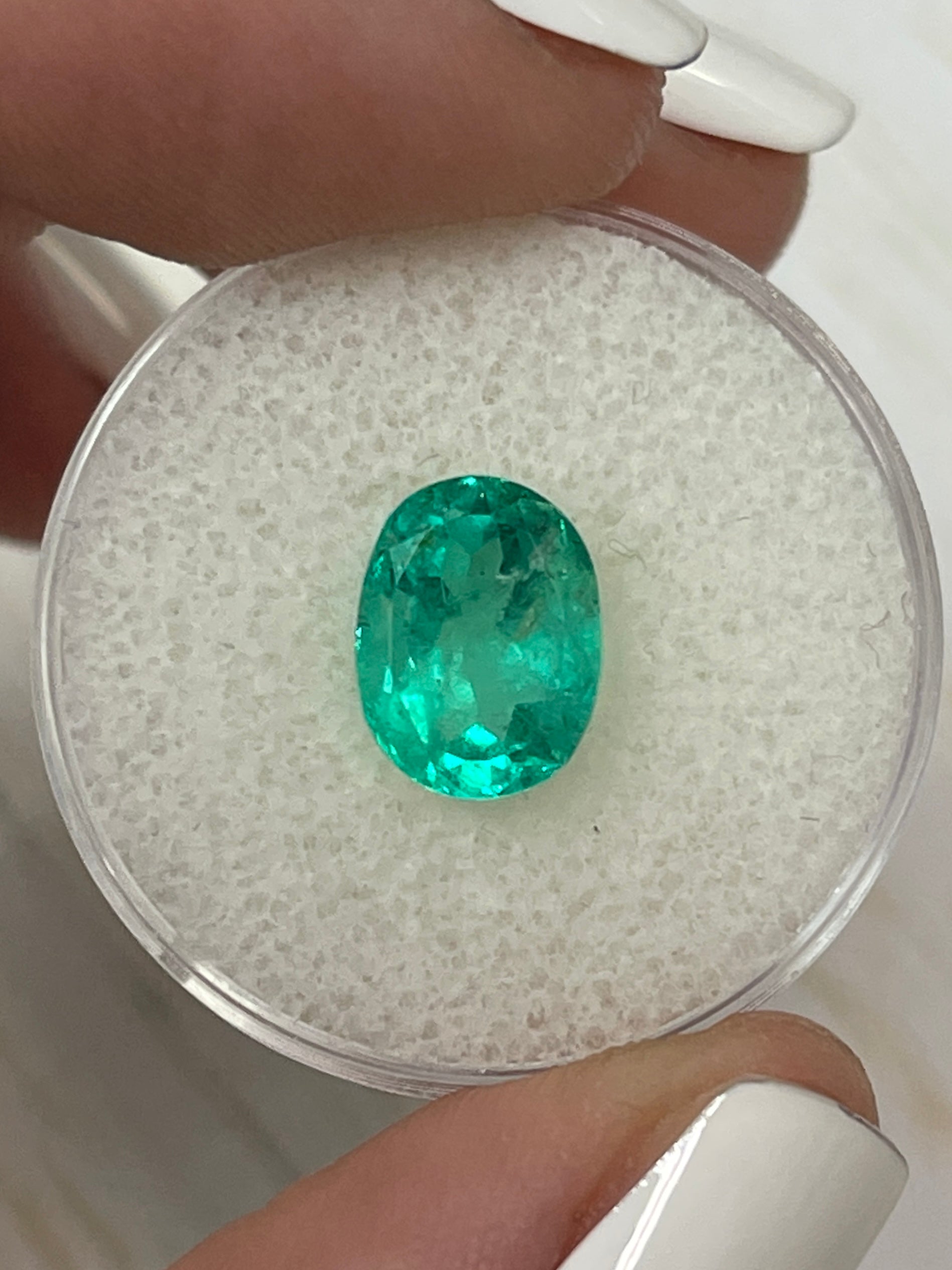 Bluish green 2.90 carat oval cut Colombian emerald from JR Colombian Emeralds, natural loose gemstone with vibrant color.
