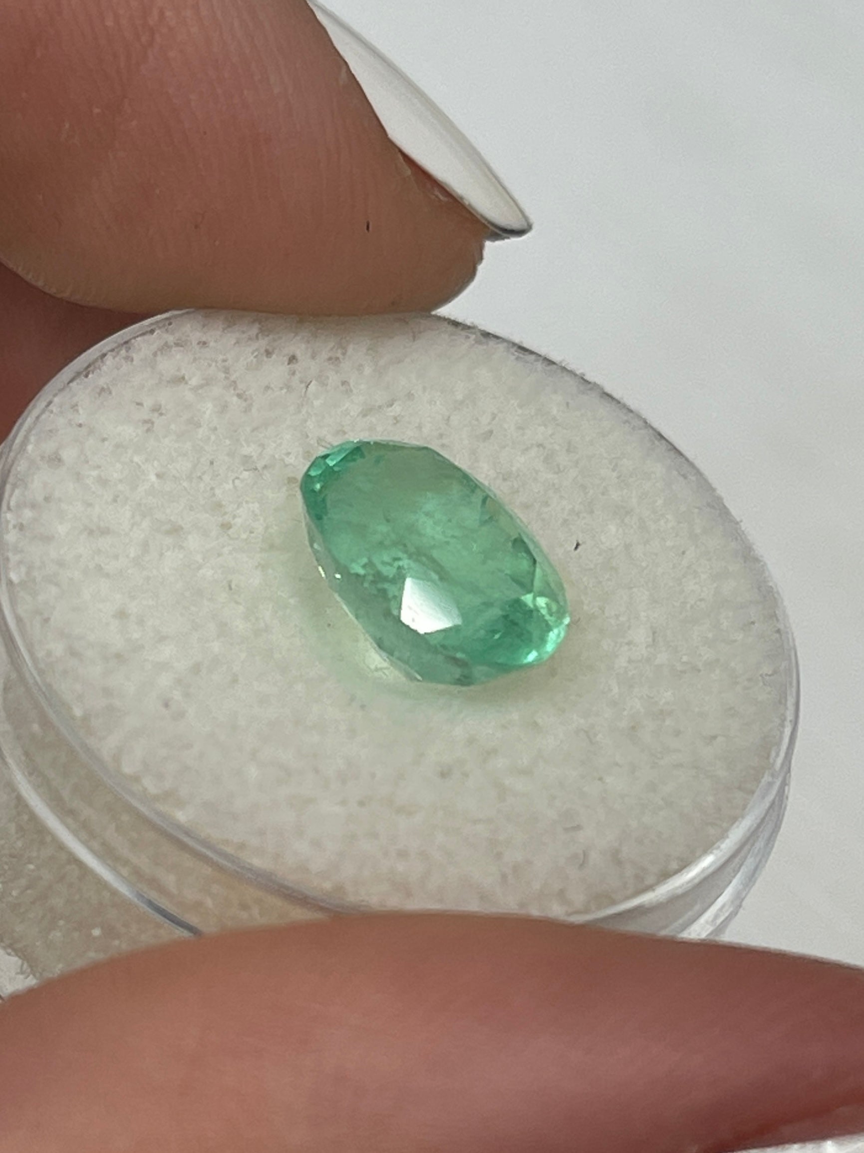 3.09 Carat pastel light green Colombian emerald loose oval cut by JR Colombian Emeralds, showcasing vibrant green color and clarity.