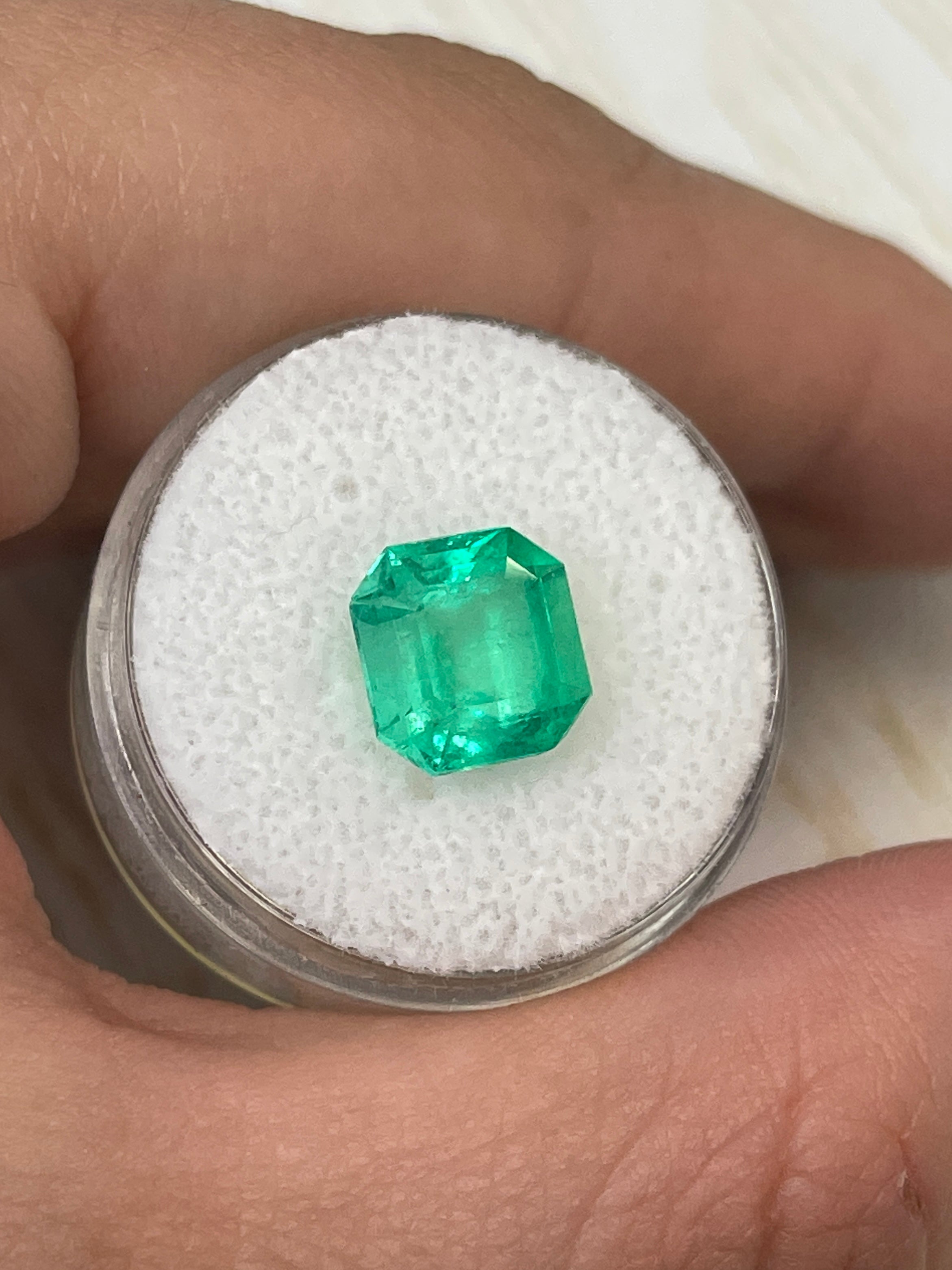 9x9mm yellowish green natural Colombian emerald loose gemstone in Asscher cut, 3.21 carats, from JR Colombian Emeralds.