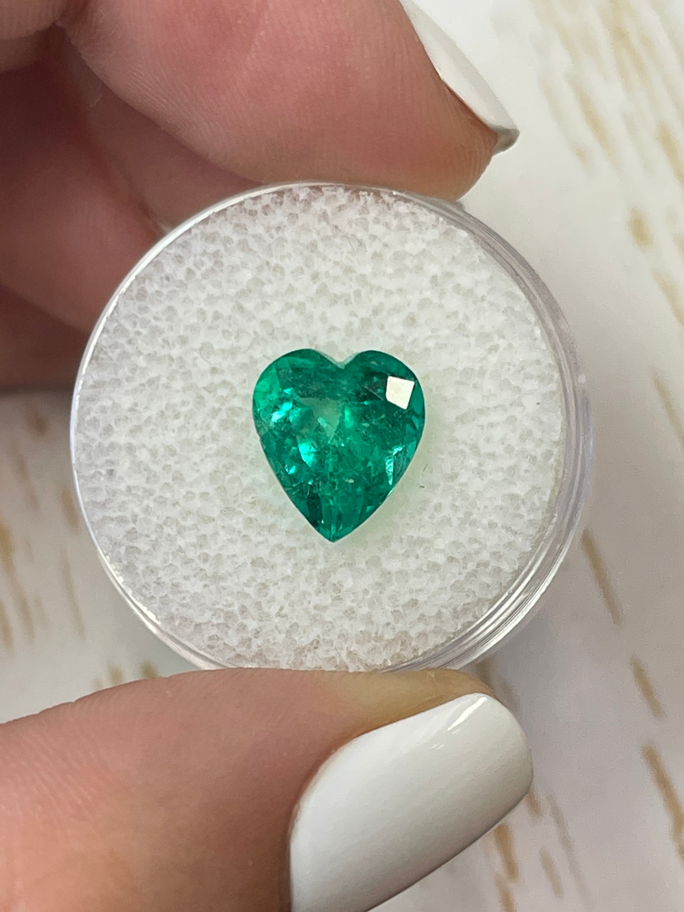 3.22 carat bluish green natural Colombian emerald loose heart cut gemstone with vibrant color and clarity.