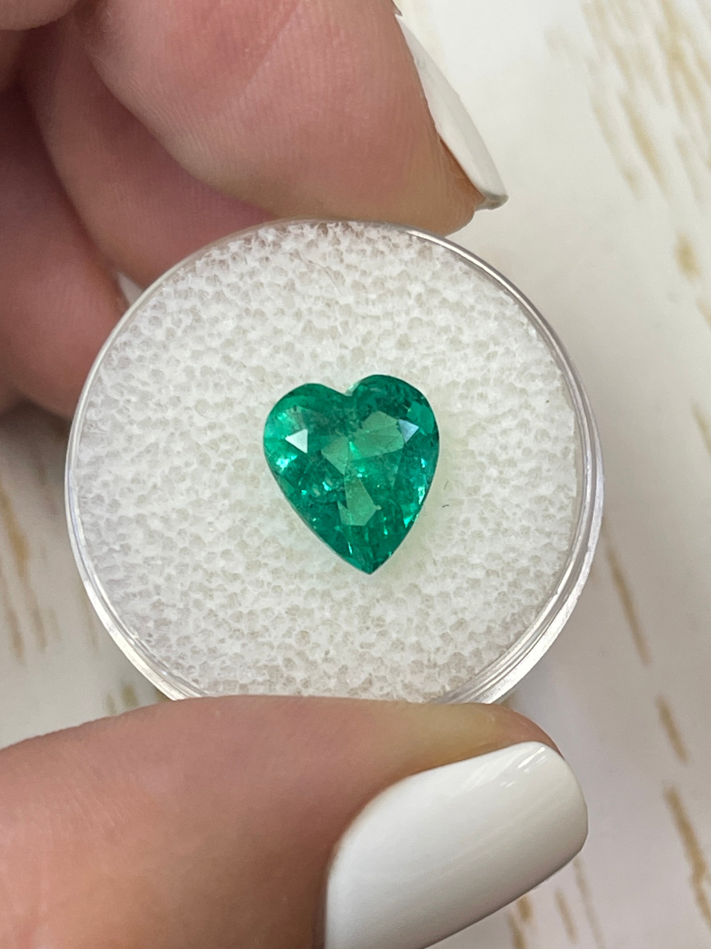 3.22 carat bluish green natural loose Colombian emerald in heart cut, showcasing vibrant color and clarity.
