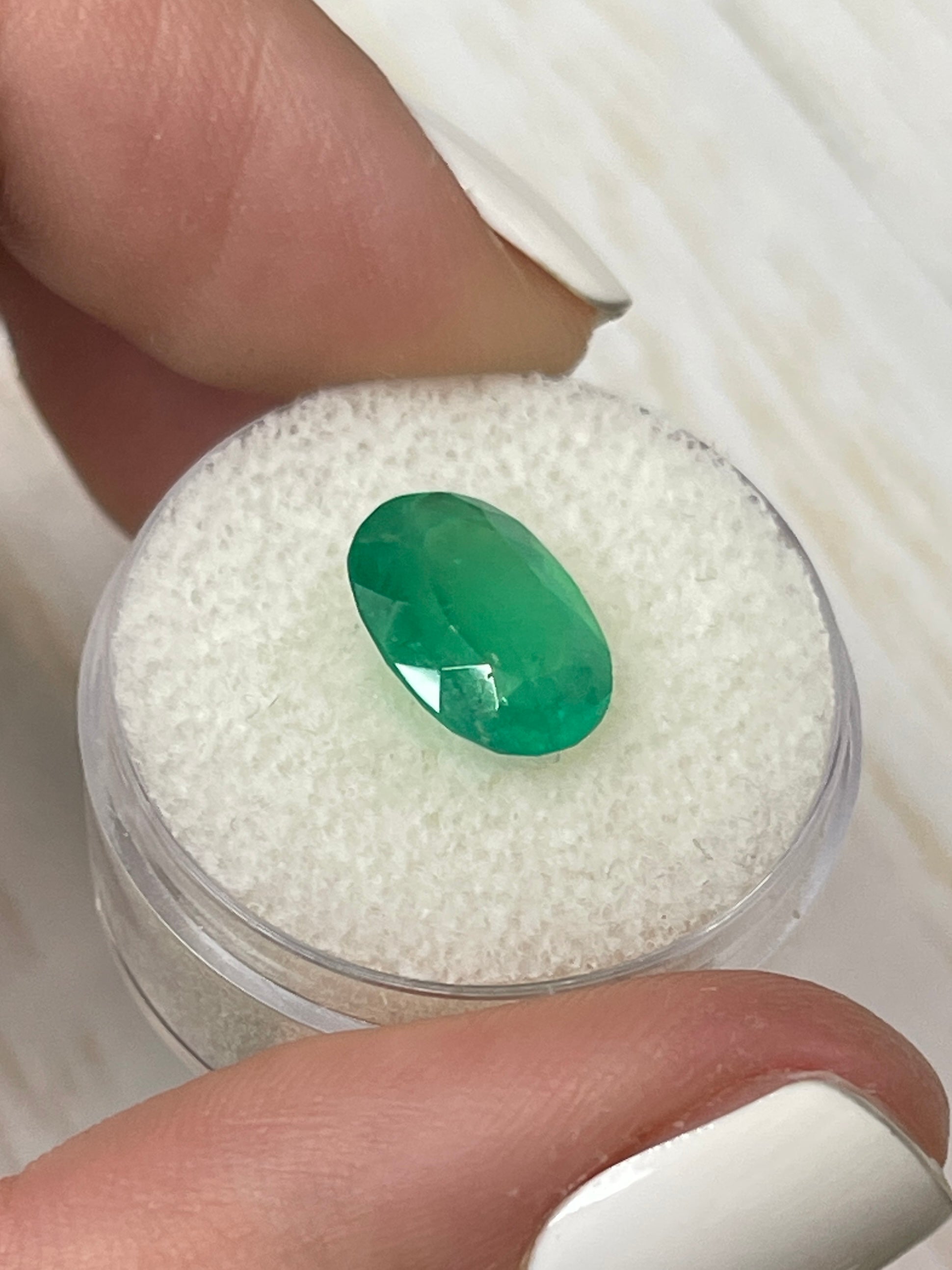 3.46 carat neon green natural Colombian emerald in oval cut, showcasing vibrant color and clarity, by JR Colombian Emeralds.