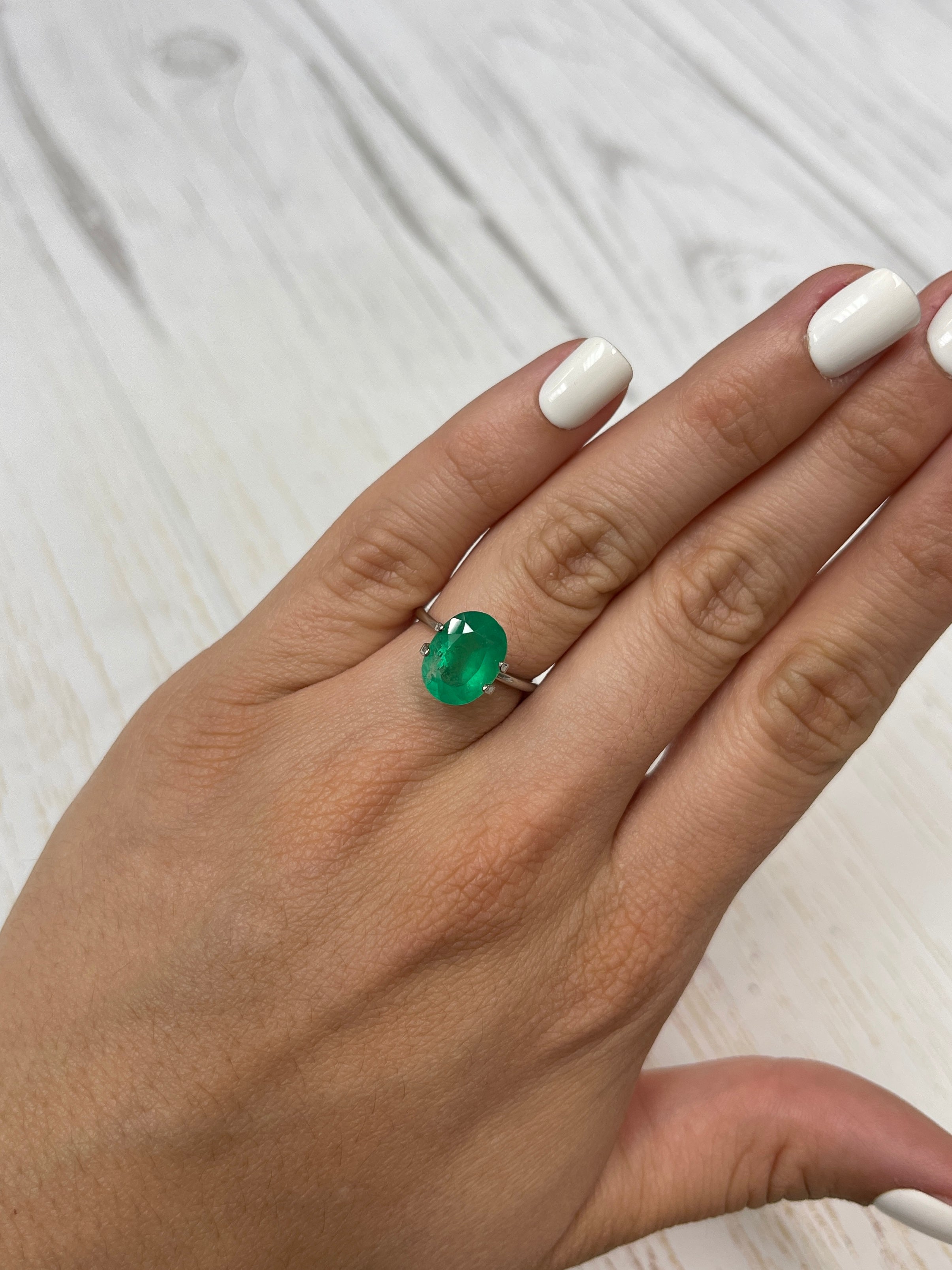 3.46 carat neon green natural Colombian emerald loose oval cut gemstone from JR Colombian Emeralds. Bright, vibrant, and highly polished.