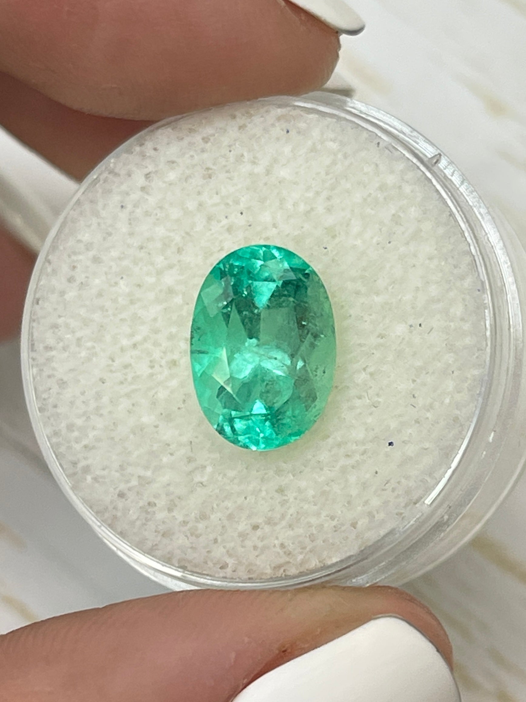 Light bluish green 3.55 carat Colombian emerald loose oval cut from JR Colombian Emeralds, showcasing vibrant, high-quality gemstone.