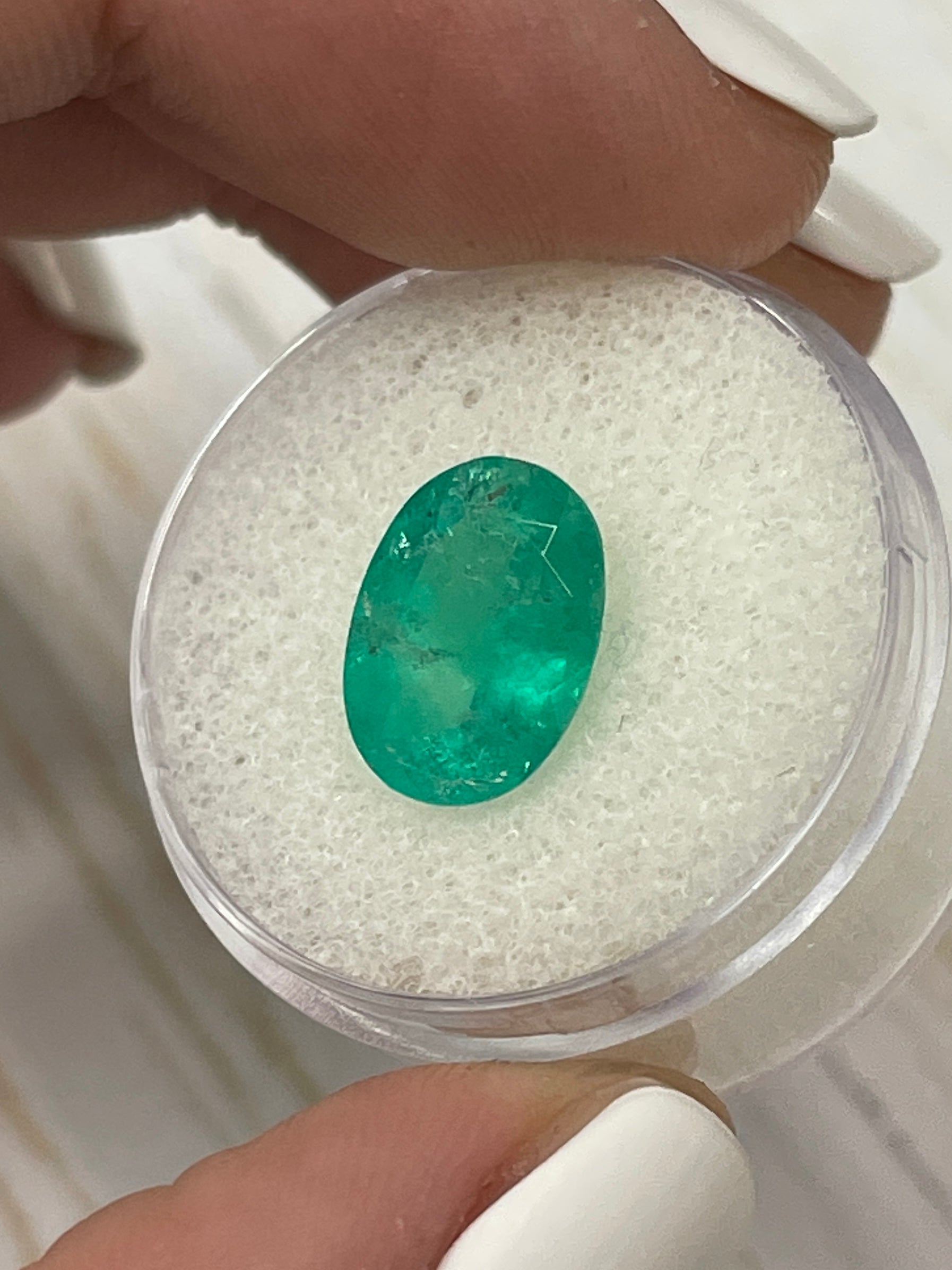 Natural 3.72 Carat Colombian Emerald in oval cut, showcasing earthy green hues, loose gemstone from JR Colombian Emeralds.