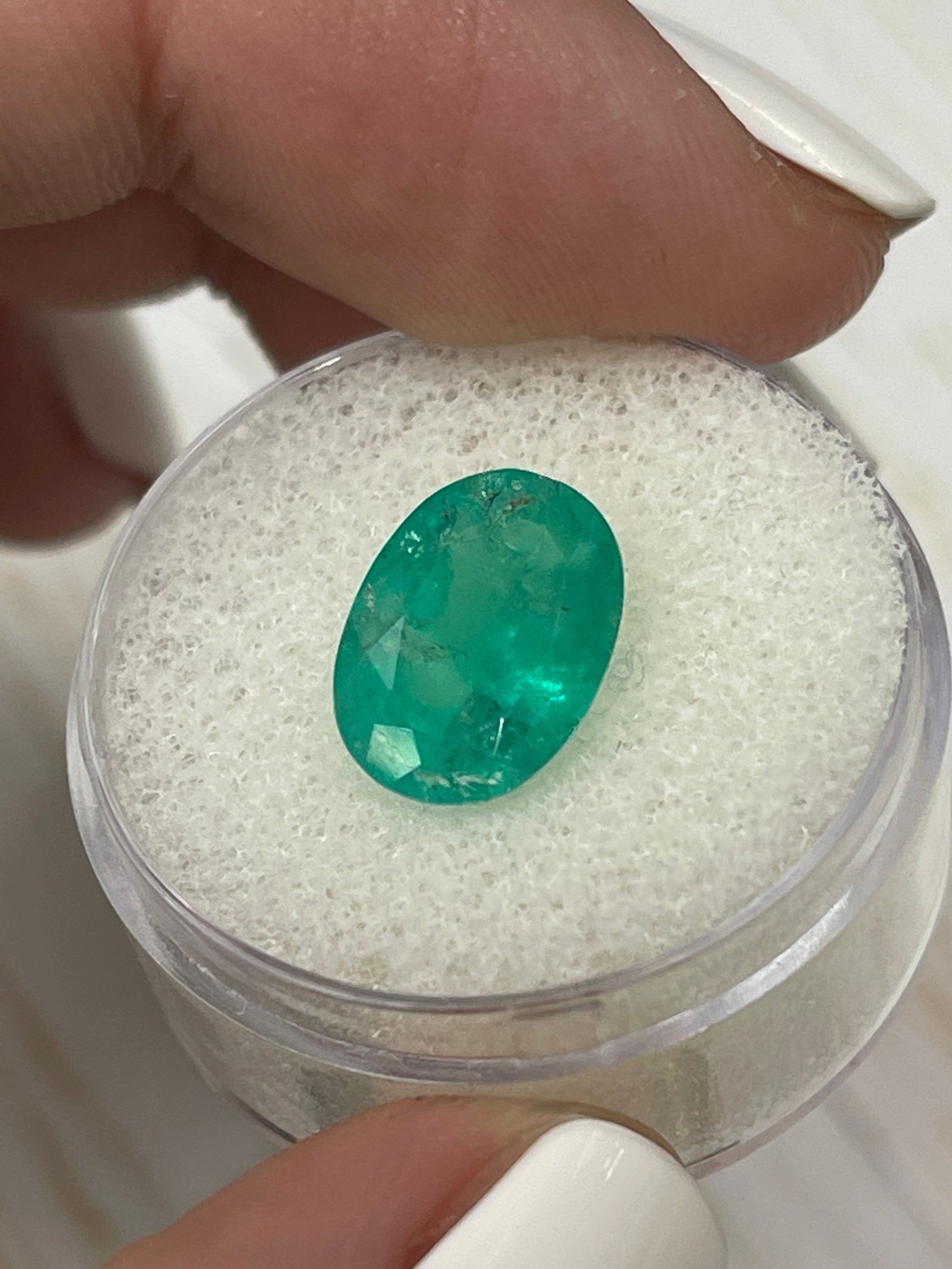 Natural 3.72 carat oval cut Colombian emerald from JR Colombian Emeralds, showcasing earthy green color and clarity.