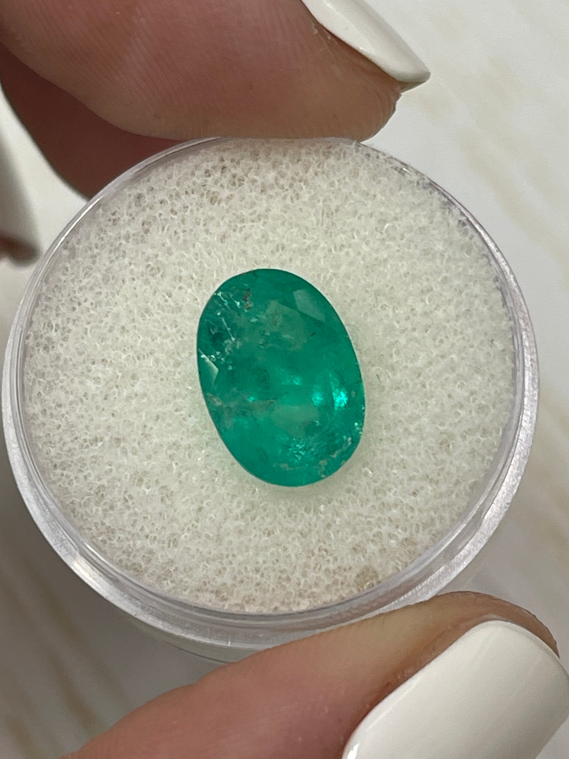 Natural 3.72 carat oval cut Colombian emerald from JR Colombian Emeralds, earthy tone, loose gemstone with vibrant green hue.