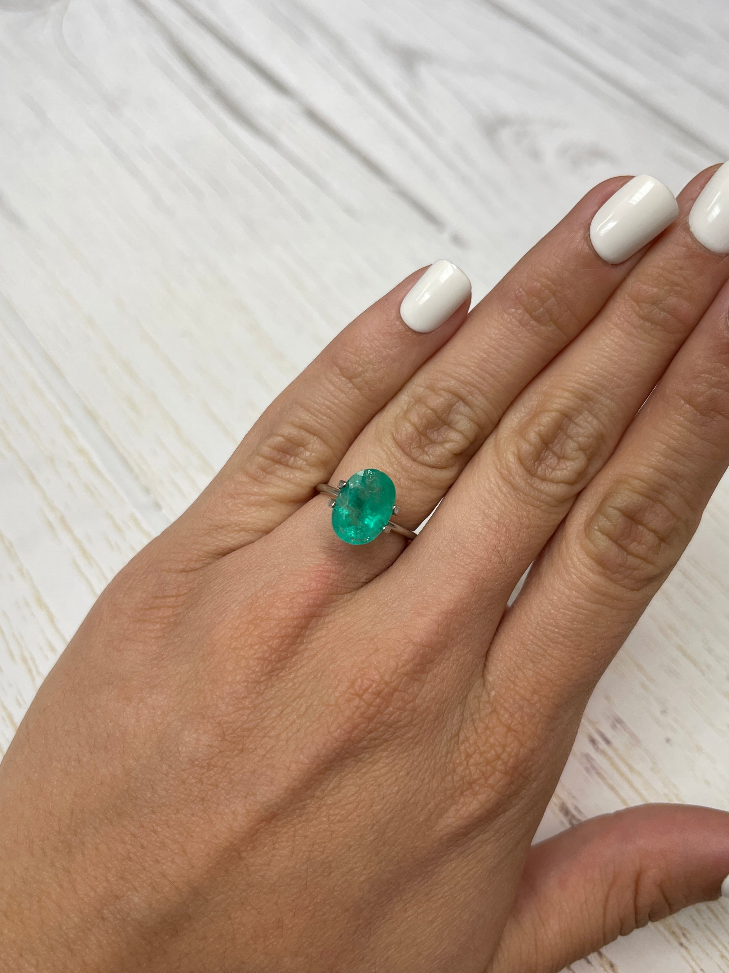 Loose 3.72 carat oval cut Colombian Emerald by JR Colombian Emeralds, showcasing earthy green hues and natural clarity.