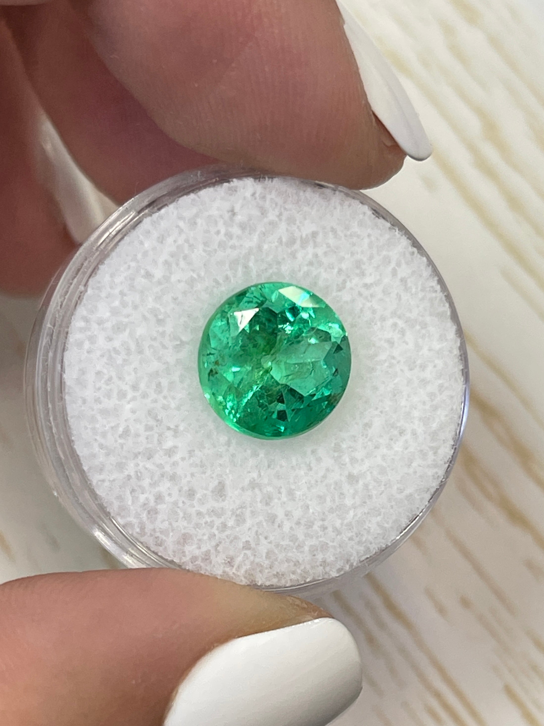 4.14 carat natural round Colombian emerald from JR Colombian Emeralds, showcasing vibrant green color and high-quality clarity.