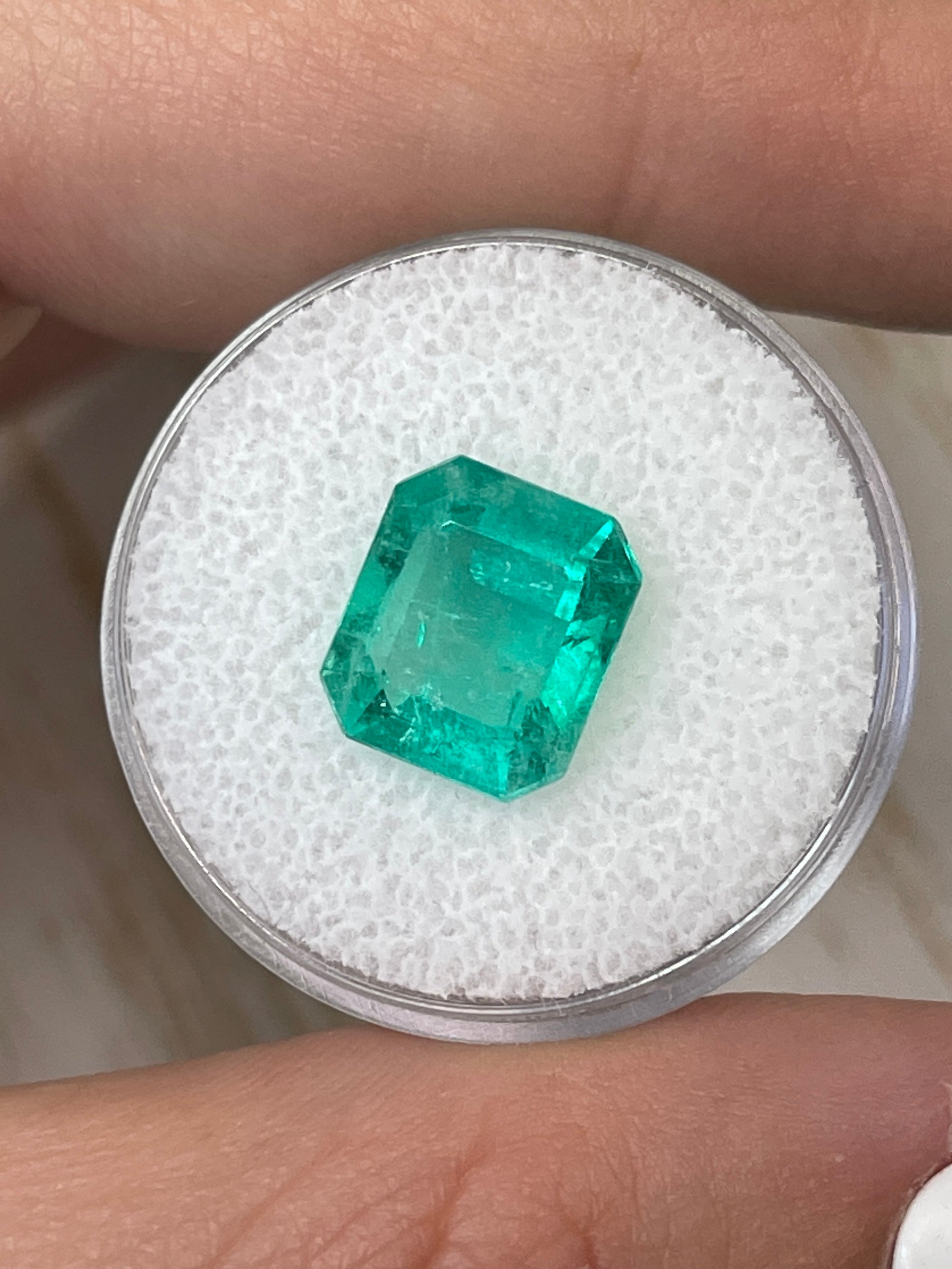 4.17 carat bluish-green natural Colombian emerald loose gemstone in classic emerald cut, displayed on a neutral background.