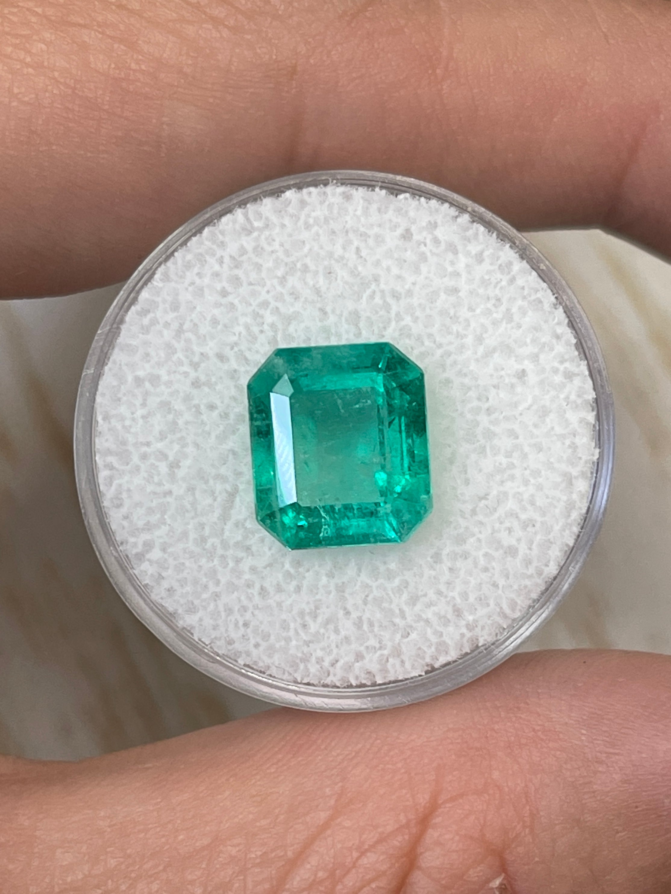 Bluish green 4.17 carat natural Colombian emerald loose gemstone in classic emerald cut, showcased by JR Colombian Emeralds.
