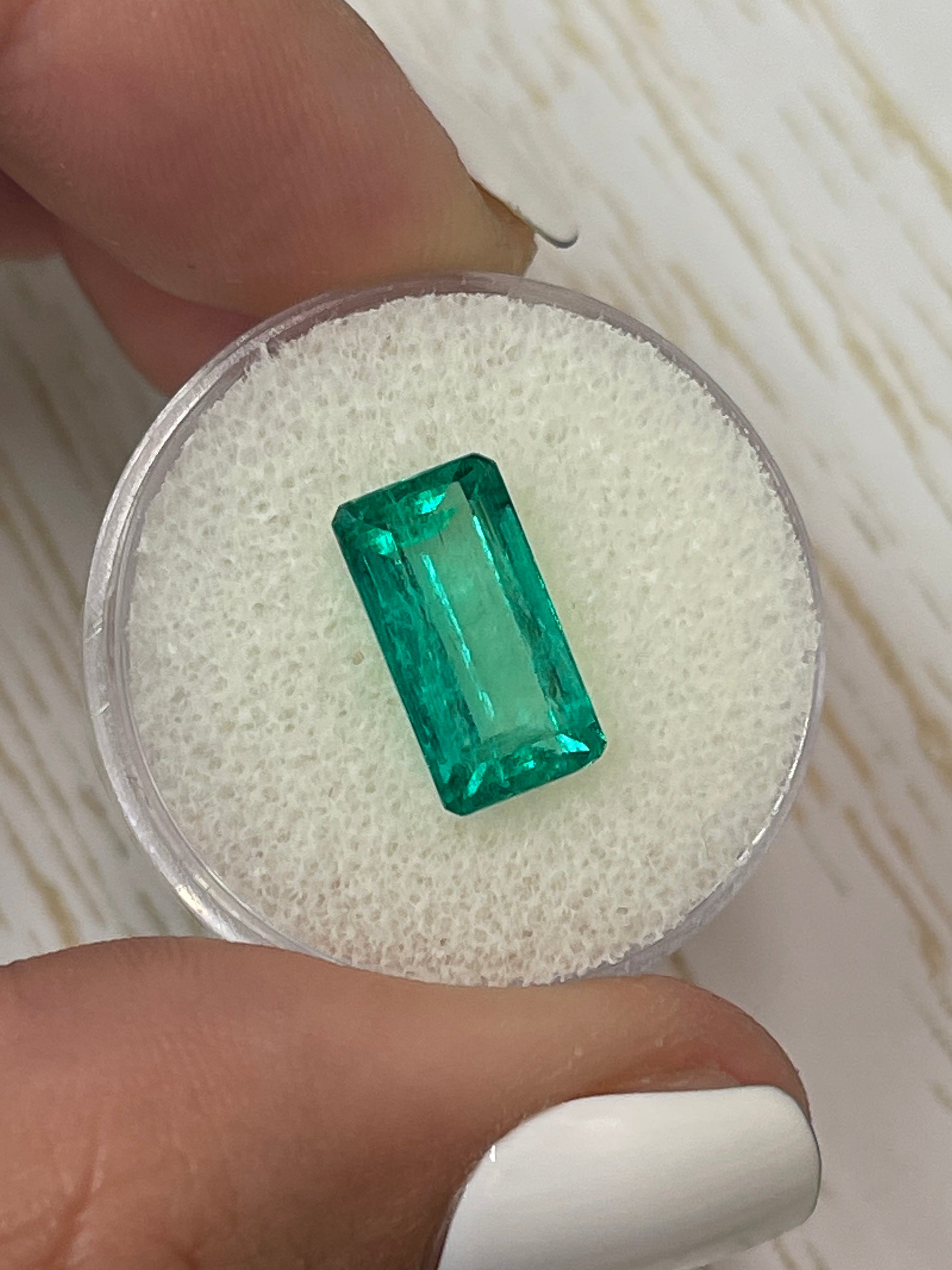 Vivid bluish green 4.26 carat natural Colombian emerald loose gemstone in elongated emerald cut, from JR Colombian Emeralds.