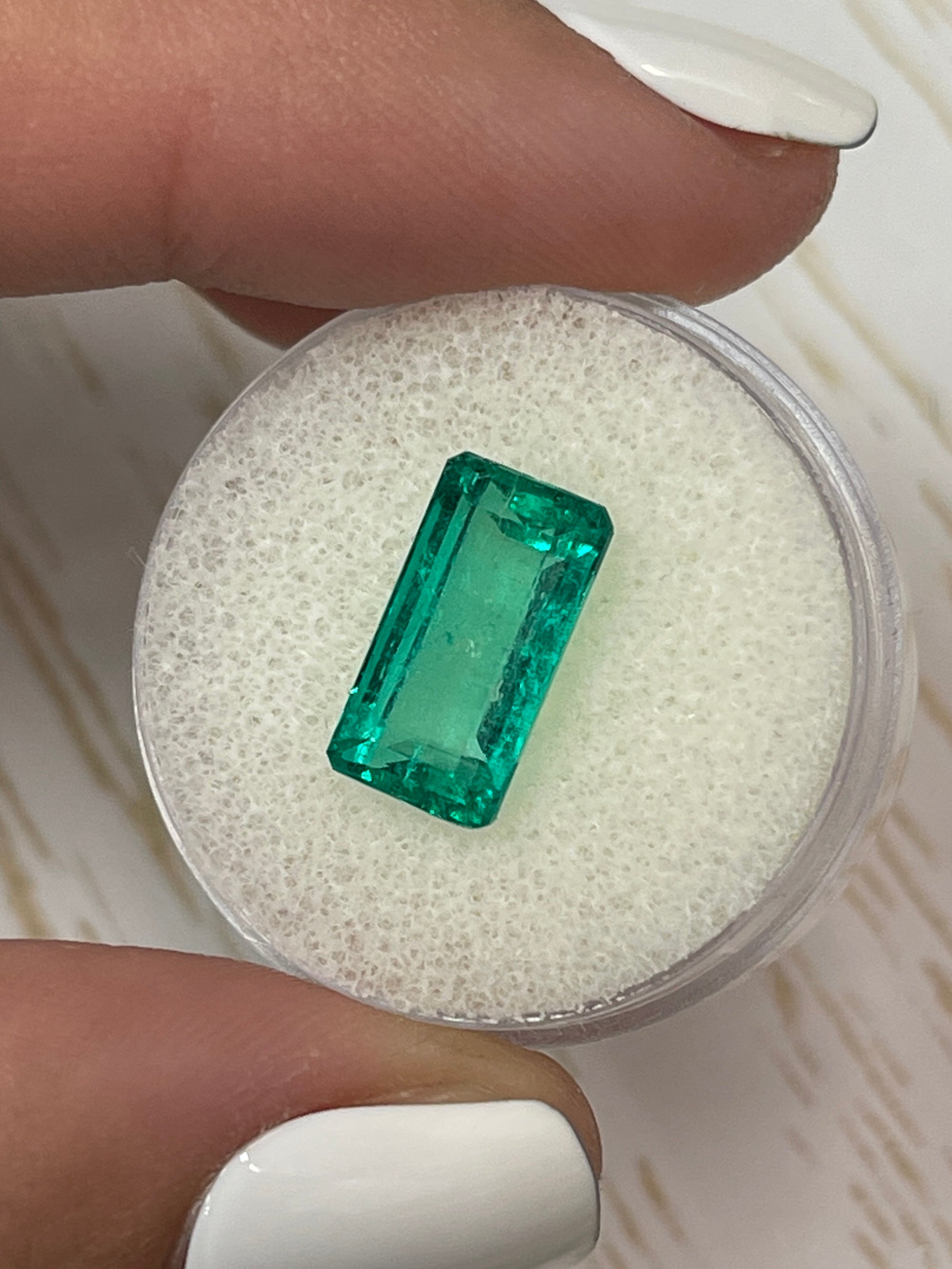 Vivid bluish green 4.26 carat Colombian emerald in elongated emerald cut, natural loose gemstone from JR Colombian Emeralds.