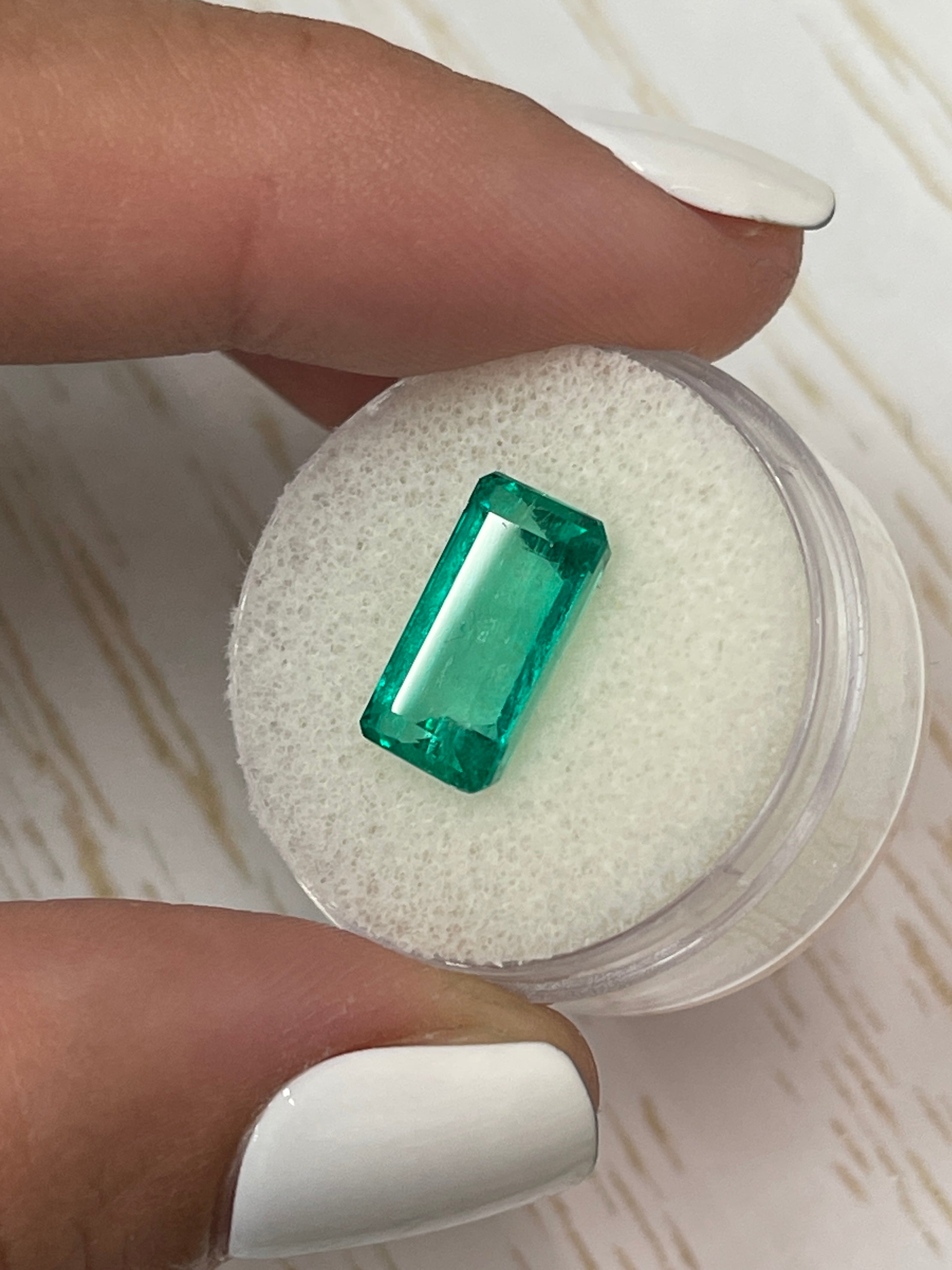 Vivid bluish green 4.26 carat natural Colombian emerald in elongated emerald cut, displayed by JR Colombian Emeralds