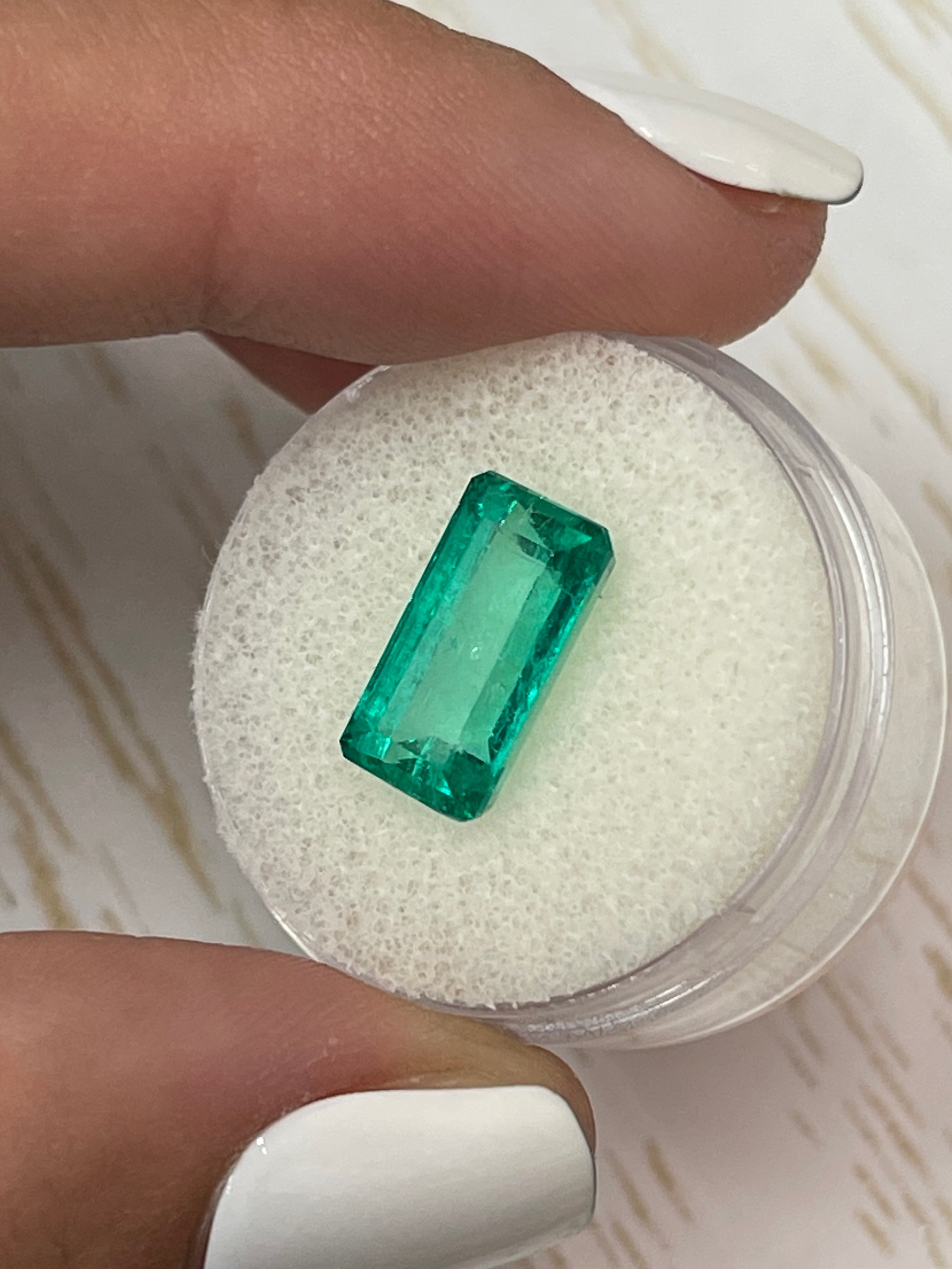 Vivid bluish green 4.26 carat Colombian emerald loose gemstone in elongated emerald cut, natural and high-quality from JR Colombian Emeralds.