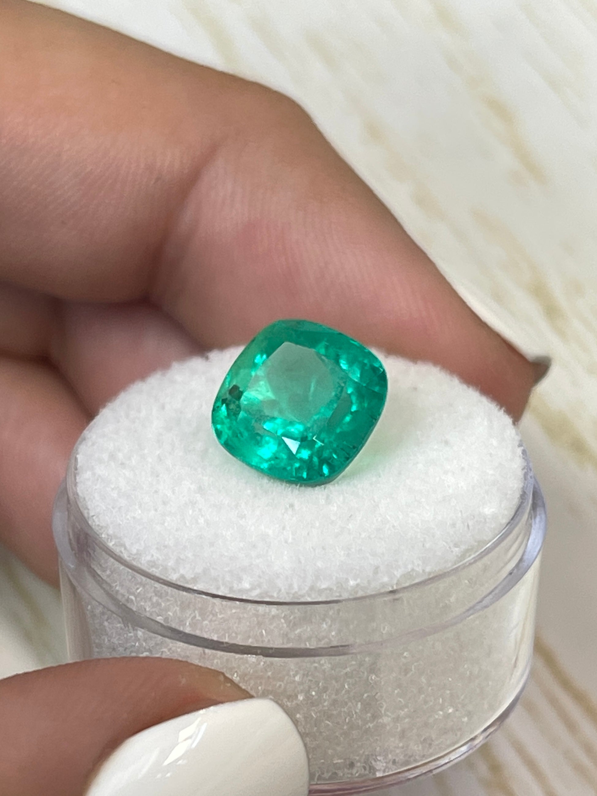 Bright green 4.72 carat Colombian emerald in cushion cut, showcasing natural clarity and vibrant color.