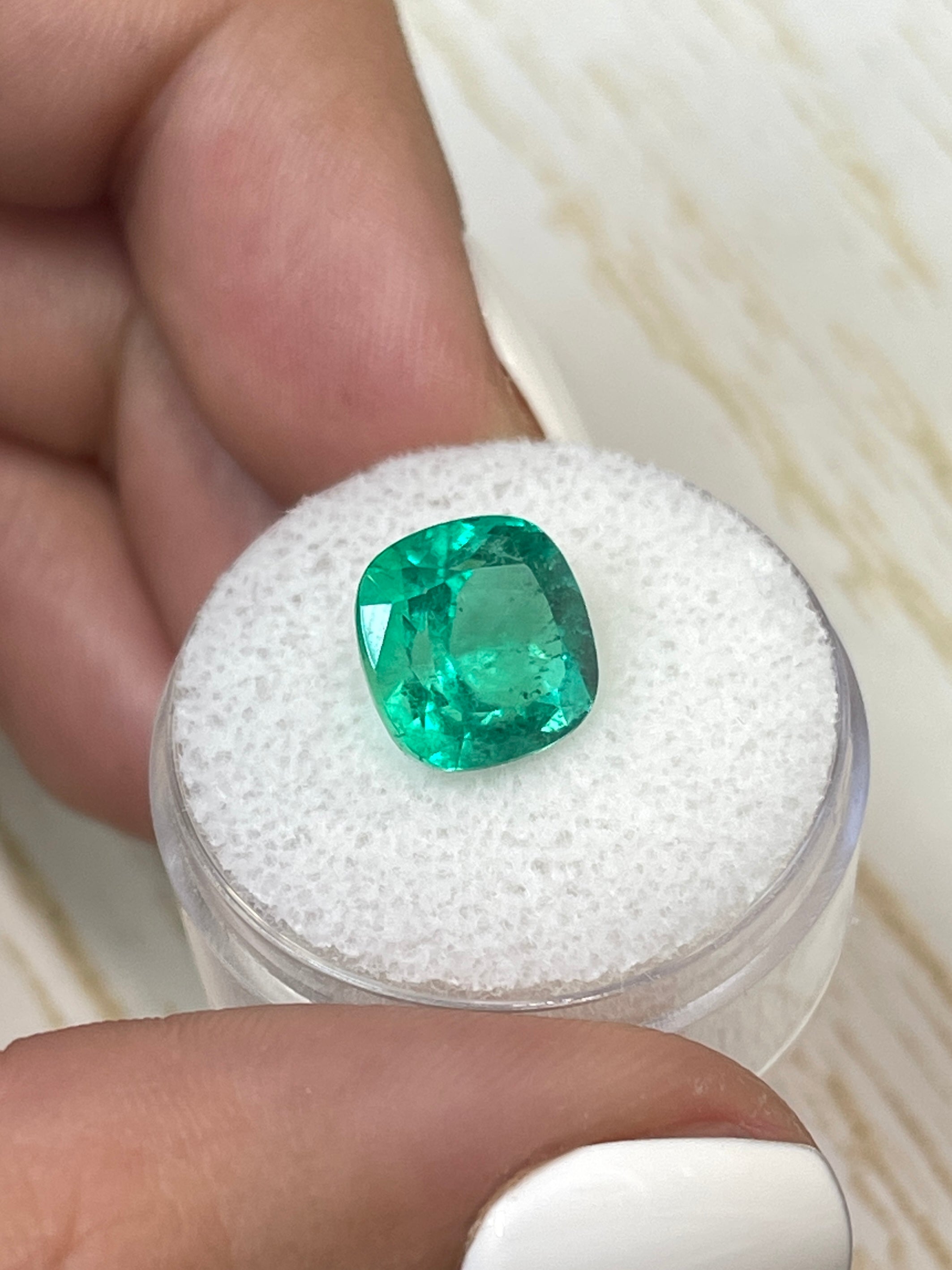 Bright green 4.72 carat Colombian emerald in cushion cut, showcasing natural brilliance and clarity.