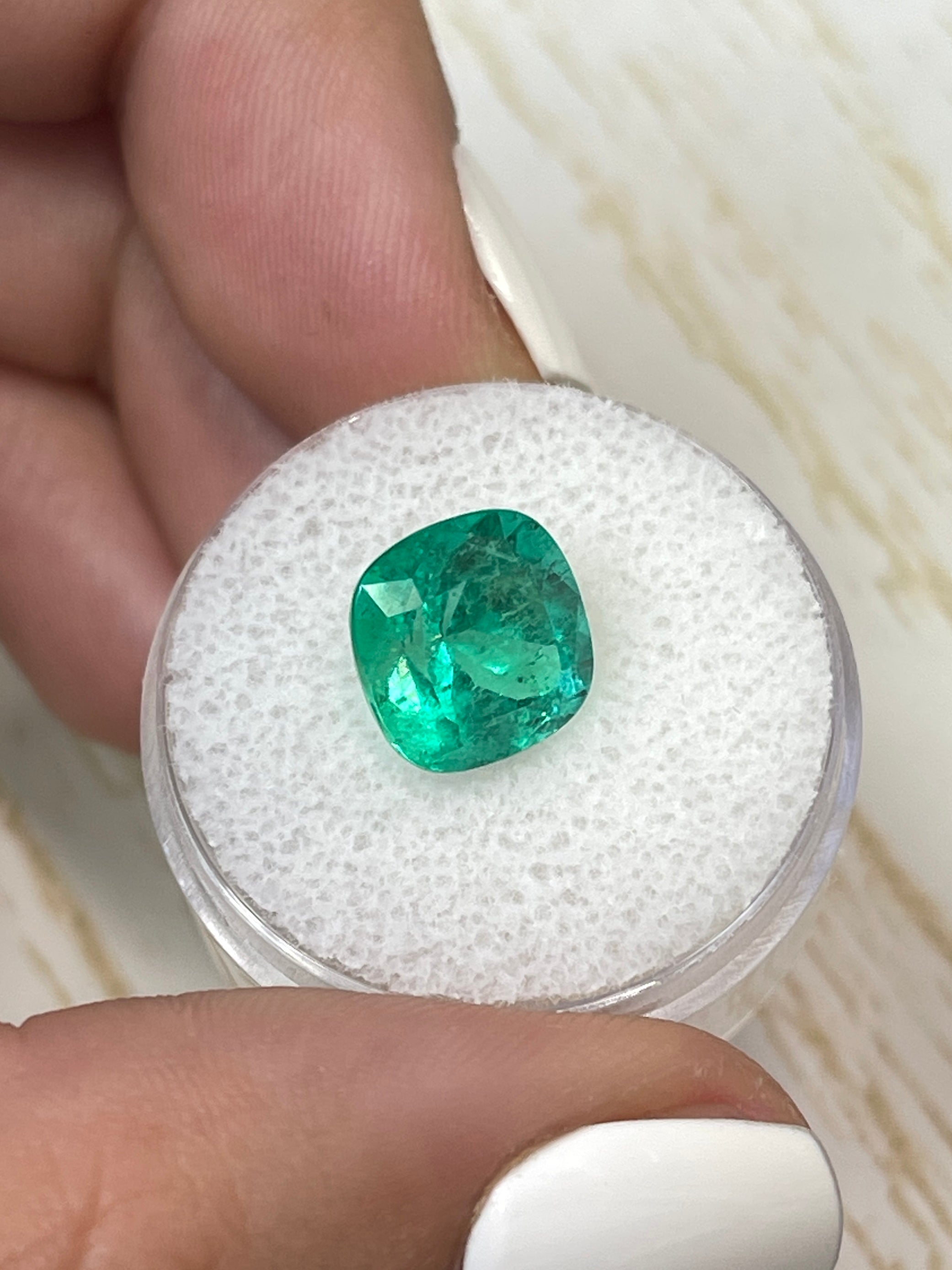 Bright green 4.72 carat natural Colombian emerald, cushion cut, showcasing vibrant color and clarity.