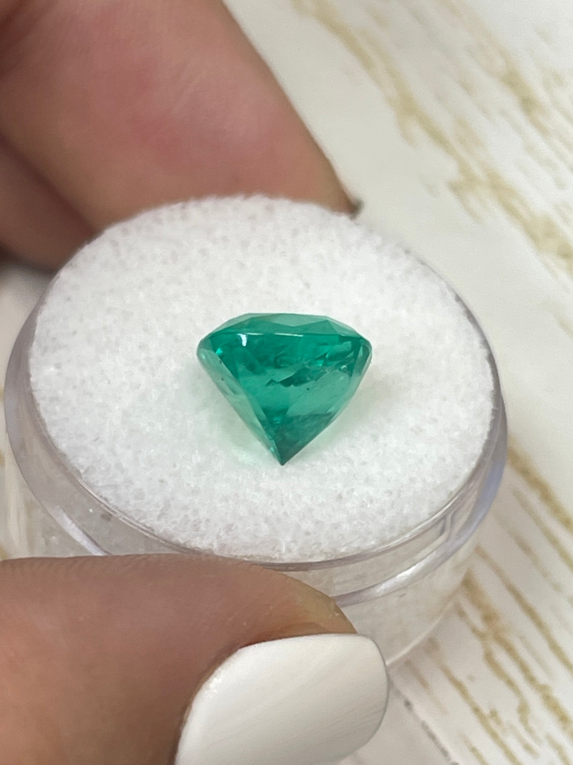 Bright green 4.72 carat Colombian emerald in cushion cut, showcasing vivid color and natural clarity.