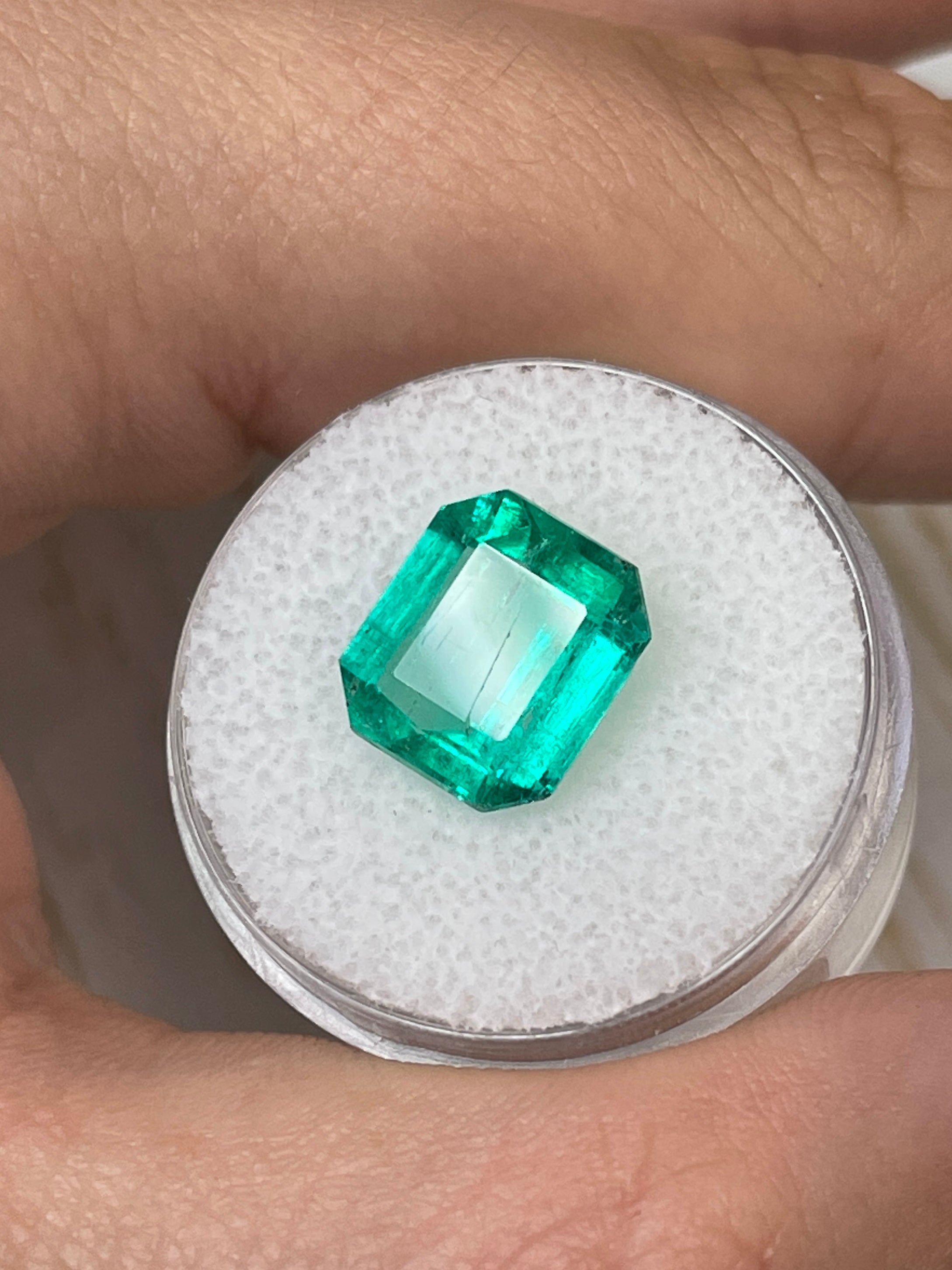 4.72 carat bluish natural Colombian emerald loose Asscher cut gemstone, showcasing rich color and clarity.
