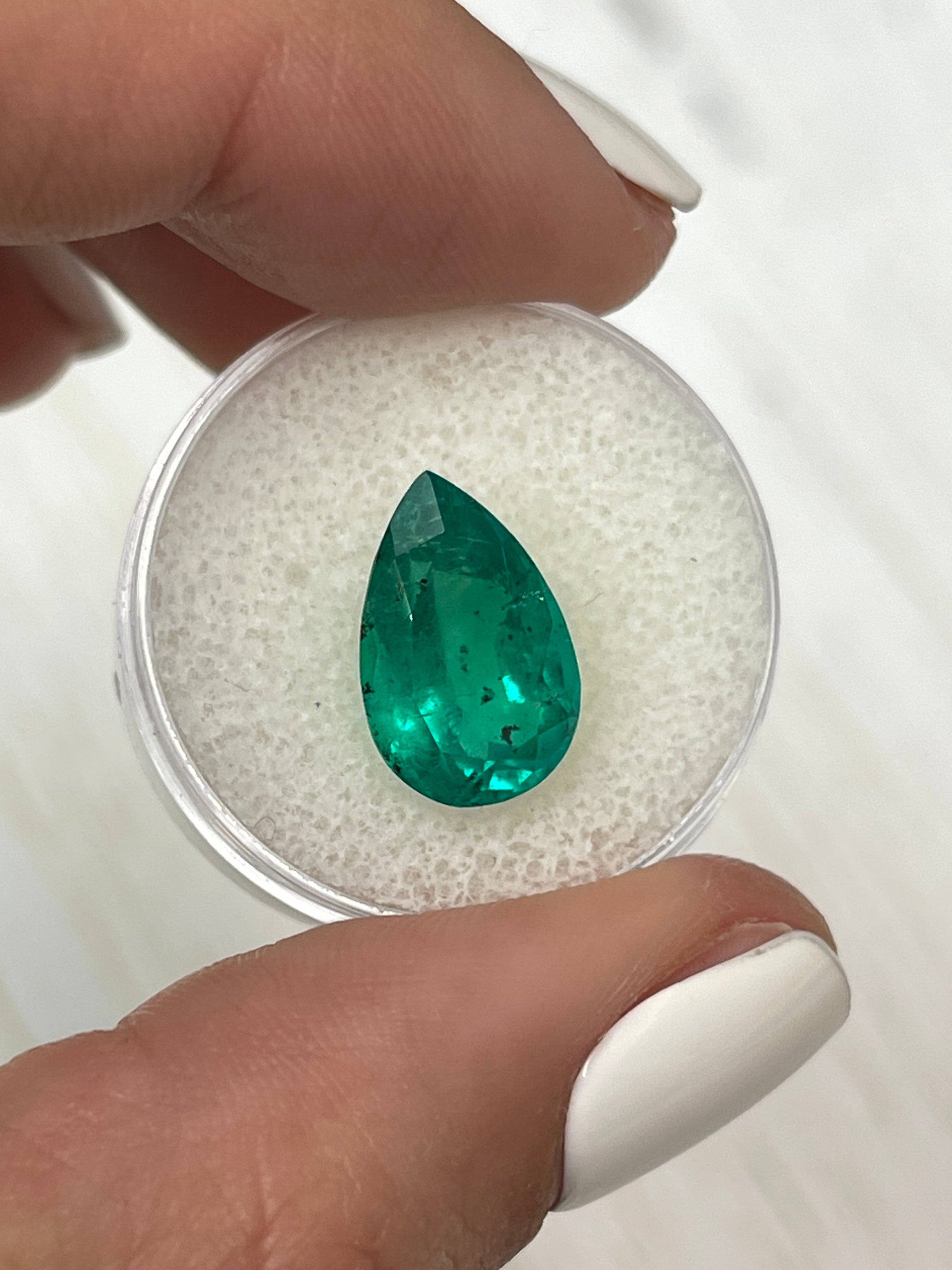 Freckled 5.18 carat Colombian emerald in pear cut, natural loose gemstone with vibrant green color, from JR Colombian Emeralds