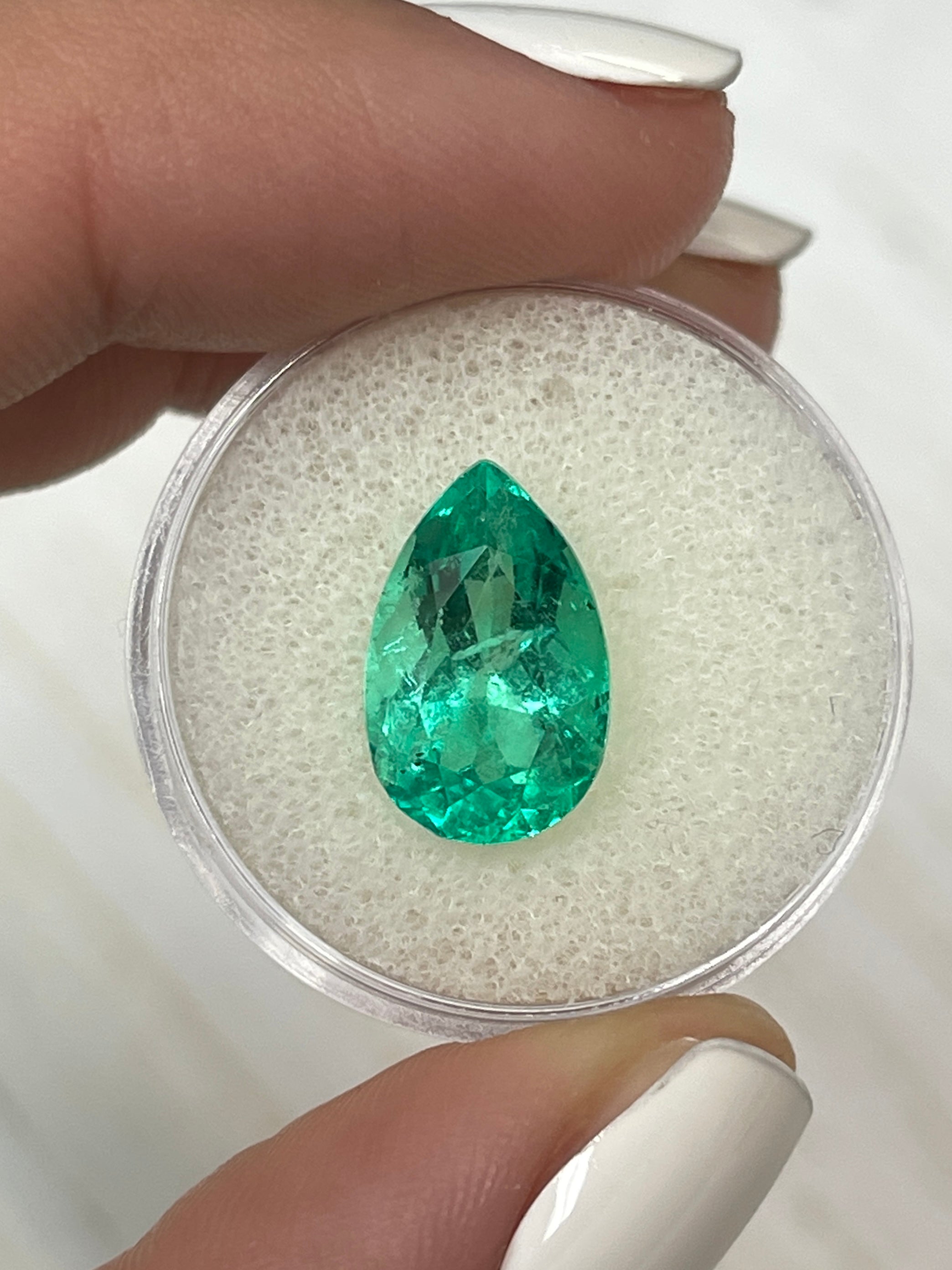 Vivid 5.21 carat Colombian emerald loose gemstone with pear cut and 14.3x9mm size, showcasing vibrant green color and clarity.