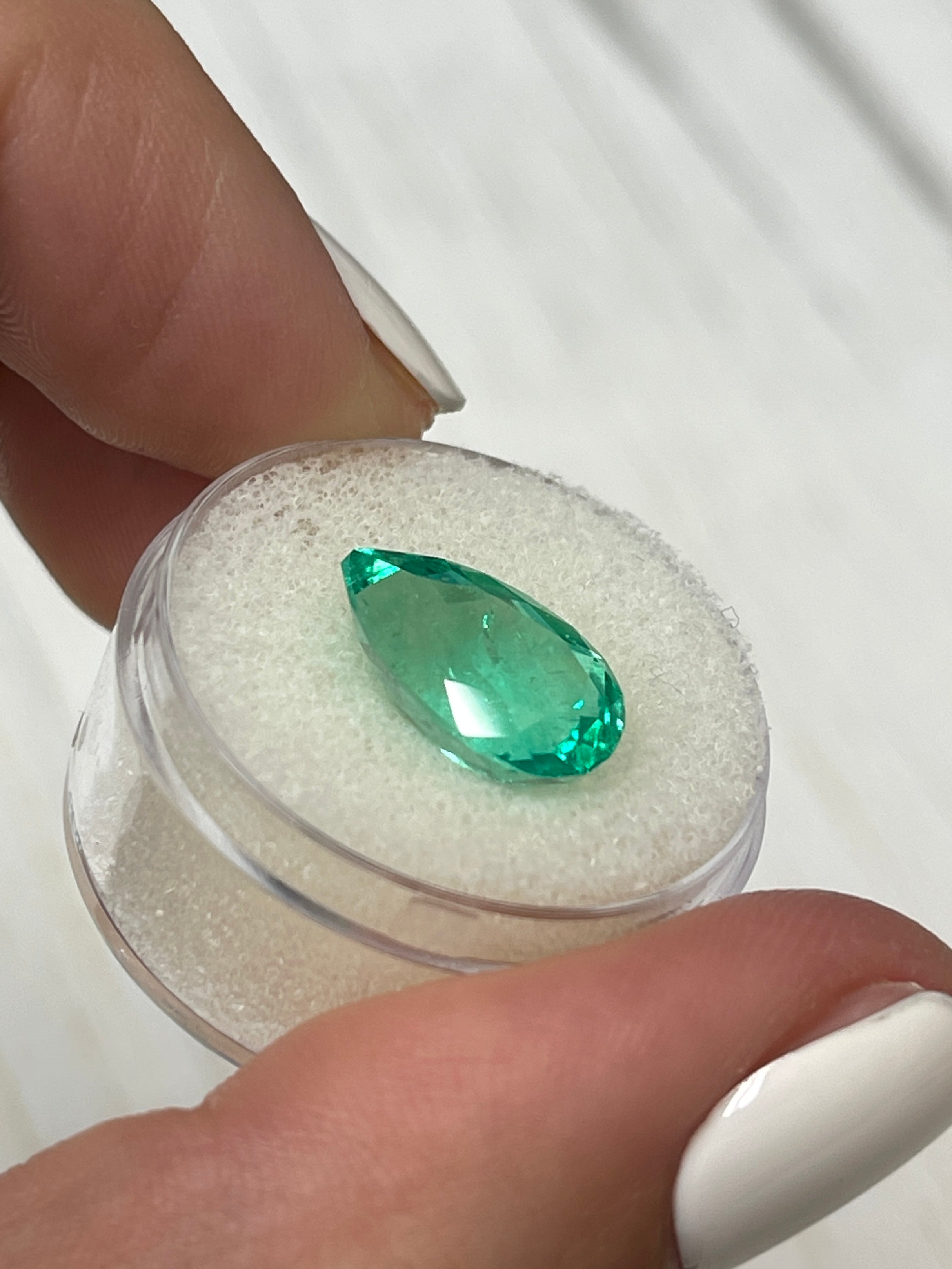 Vivid 5.21 carat natural Colombian emerald in pear cut, 14.3x9mm, showcasing vibrant green color and clarity.