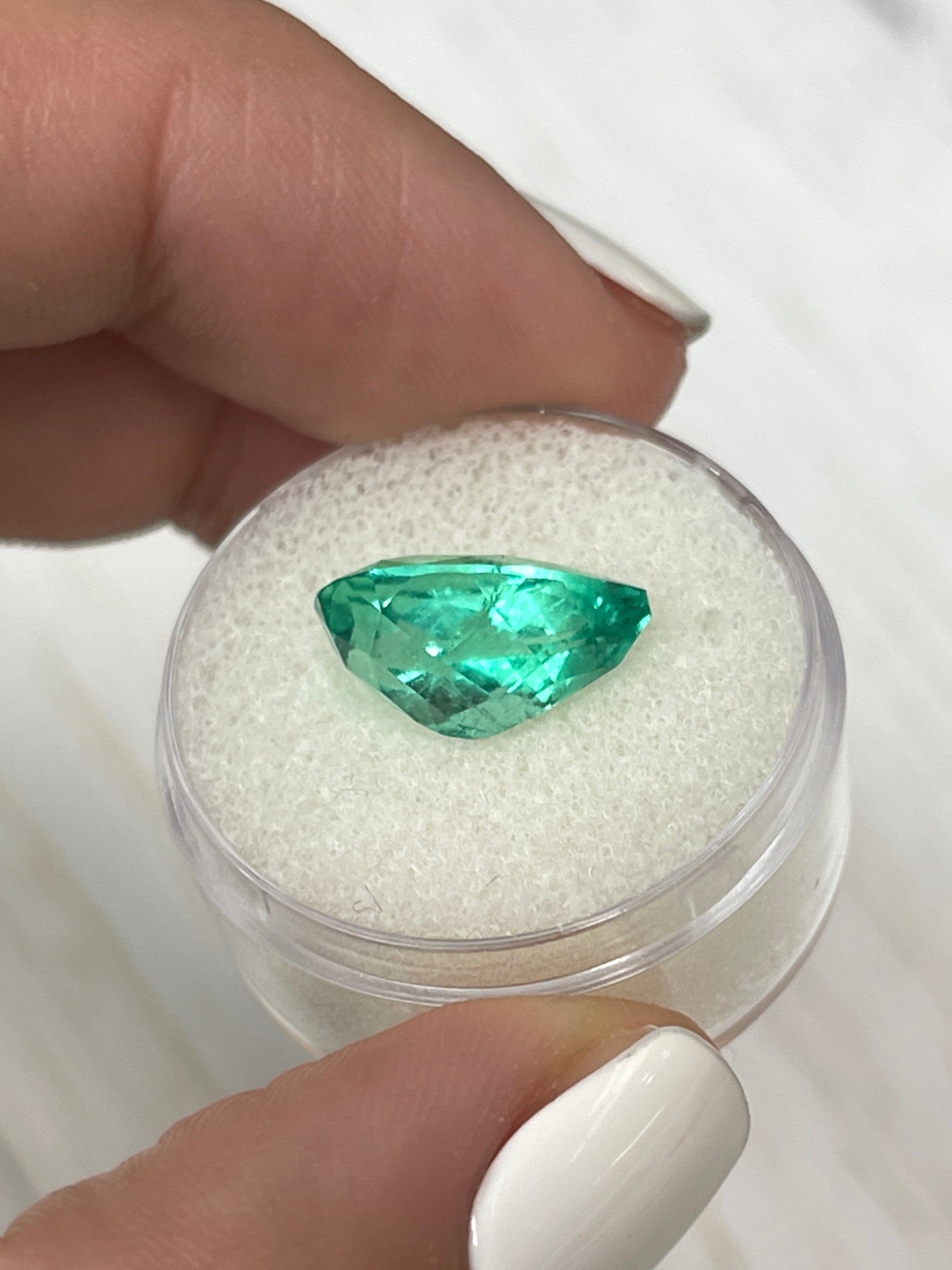 Vivid 5.21 carat natural Colombian emerald in pear cut with 14.3x9mm size, displayed by JR Colombian Emeralds.